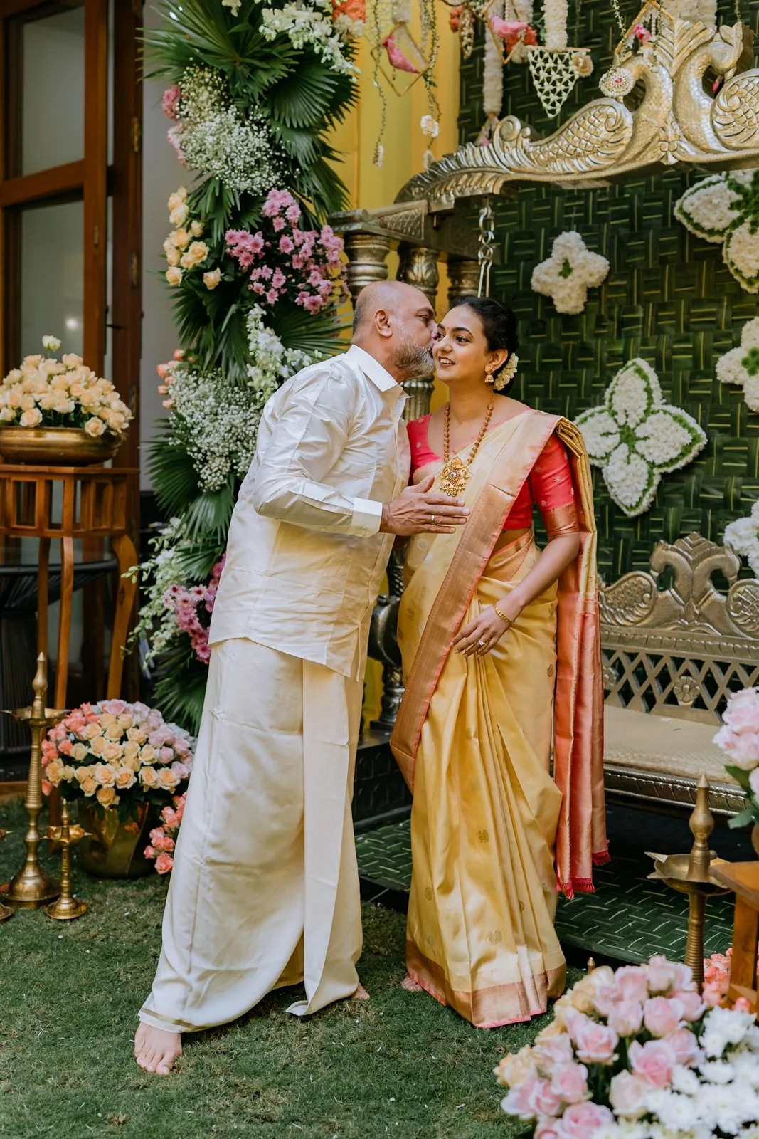 Father kissing Shrishti on the cheek at her haldi