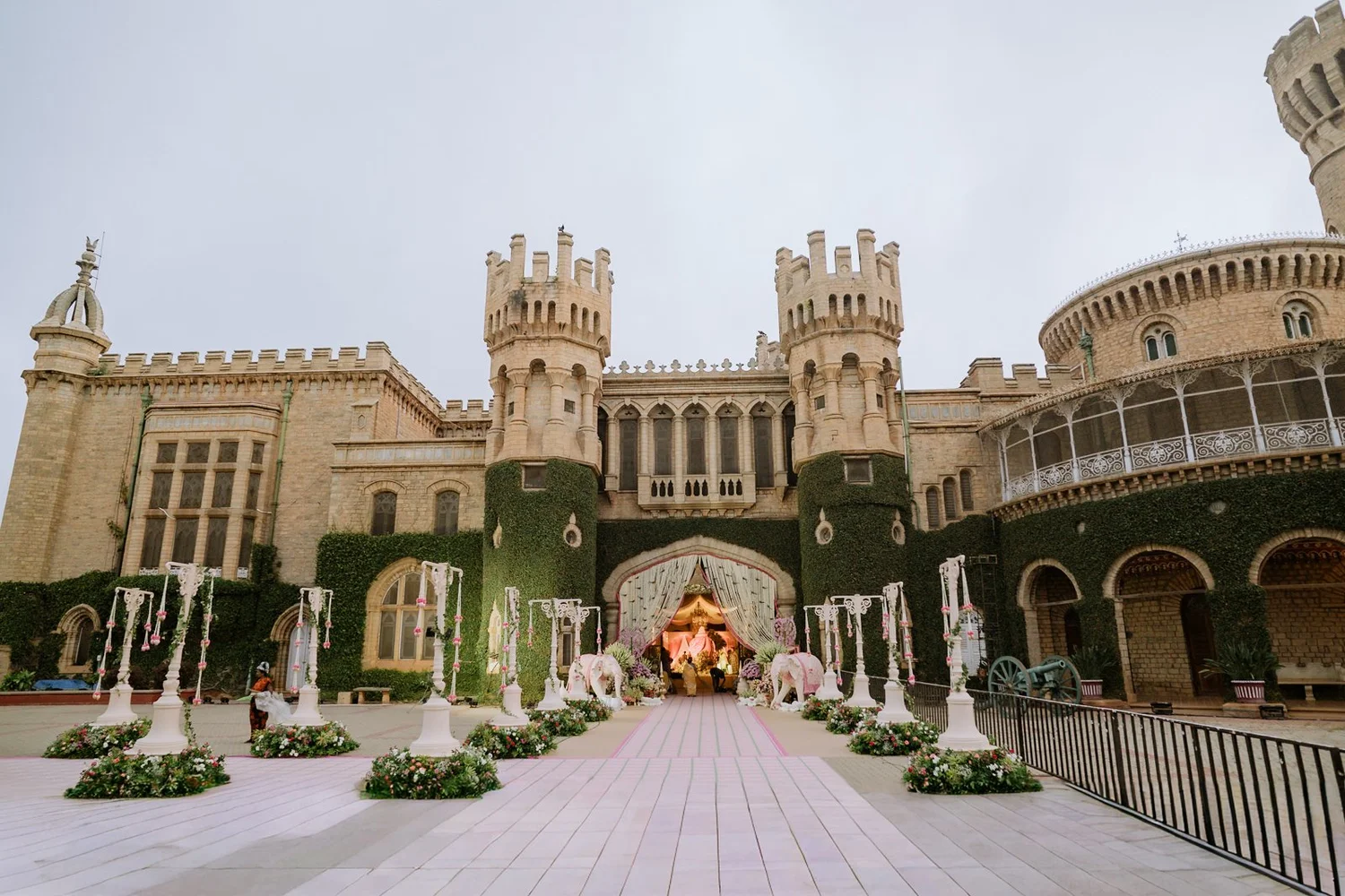 Wide view of Bangalore Palace and the decorated wedding aisle by Blue Water Productions