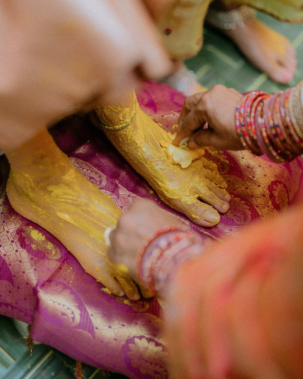 Turmeric being applied to Shrishti's feet