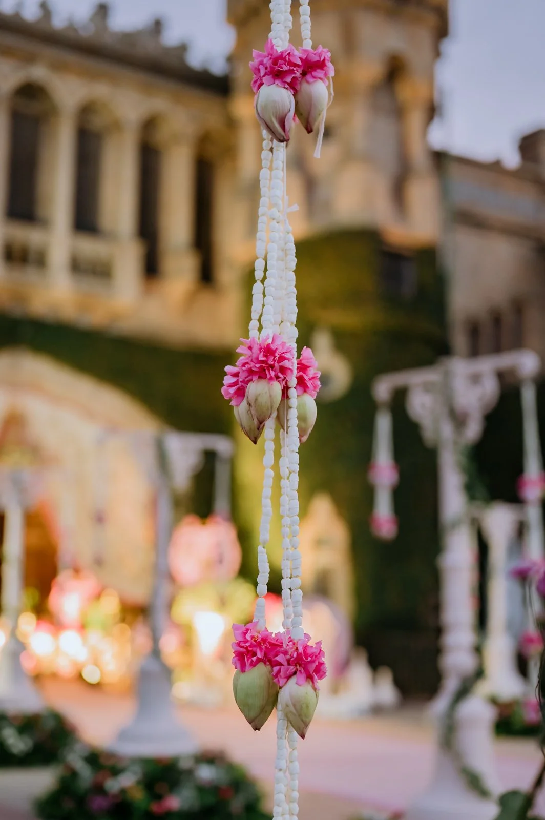Strings of lotus buds and jasmine against the Bangalore Palace facade