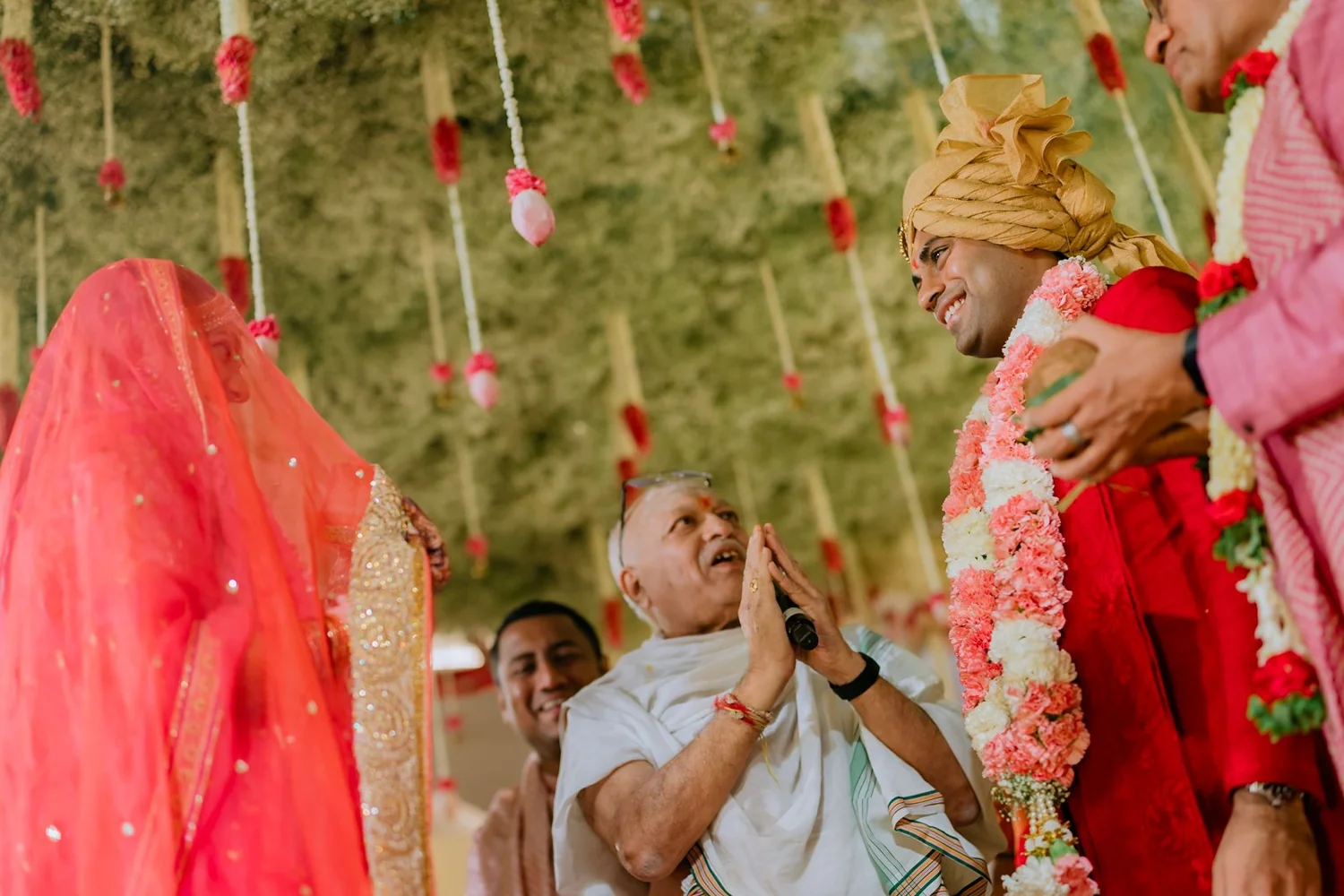 Akhil smiling as the priest prays before the antarpata