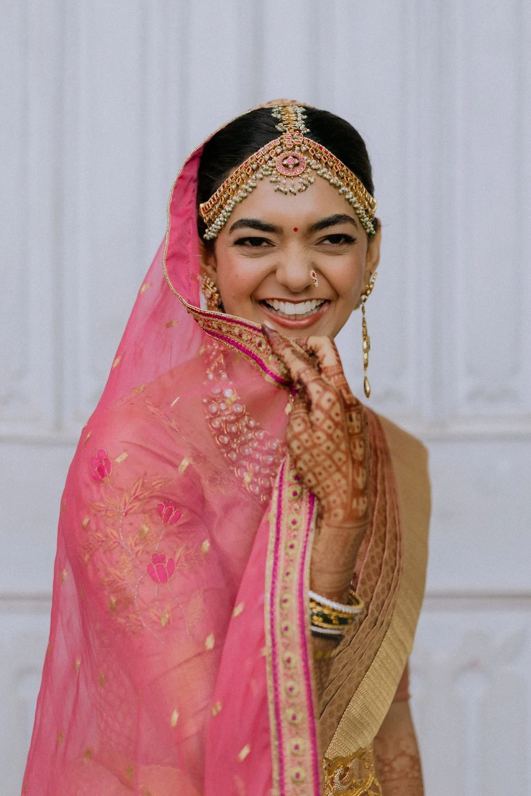 Shrishti laughing in her pink bridal veil