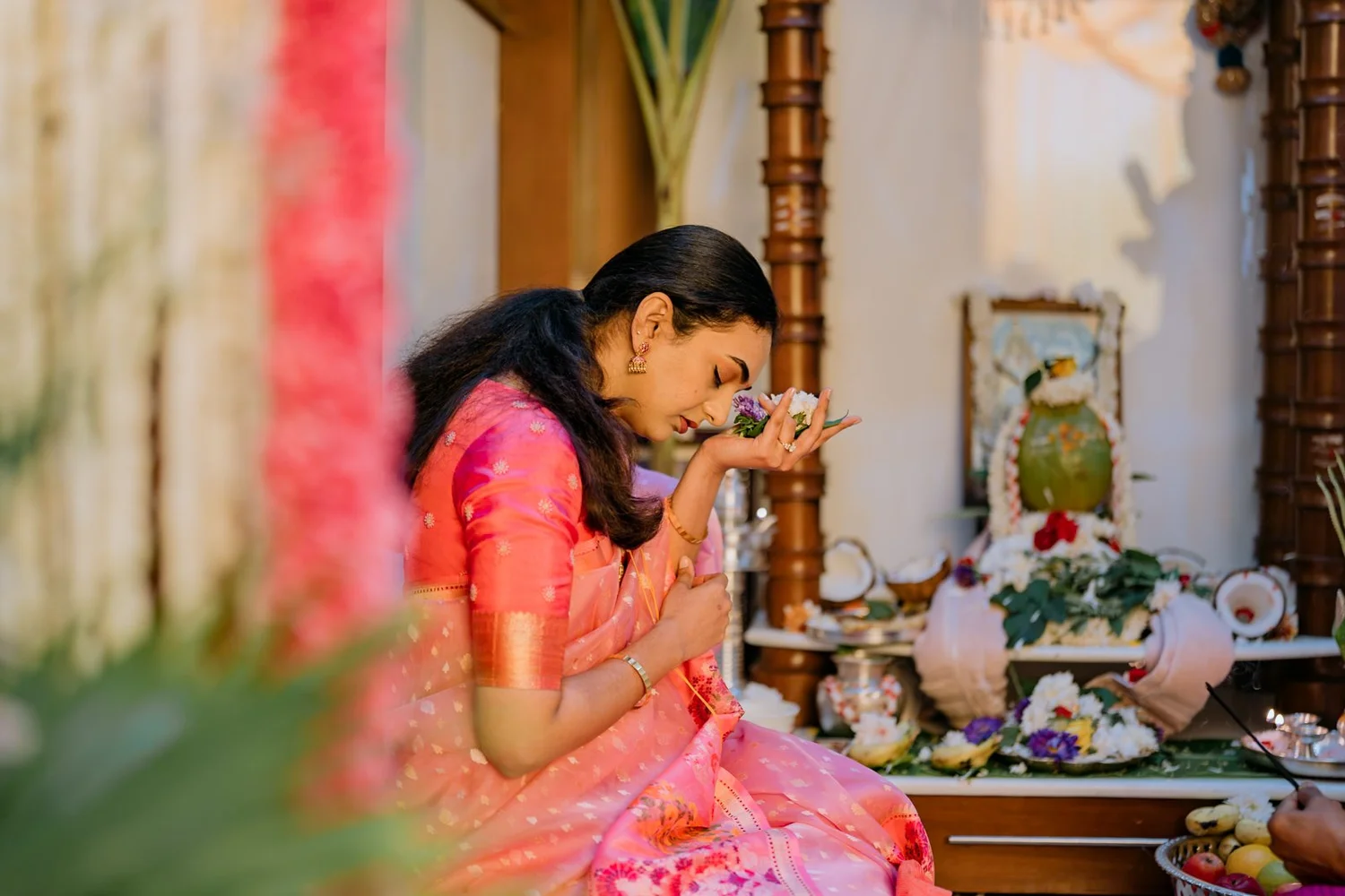 Shrishti offering a prayer at the home altar before the haldi