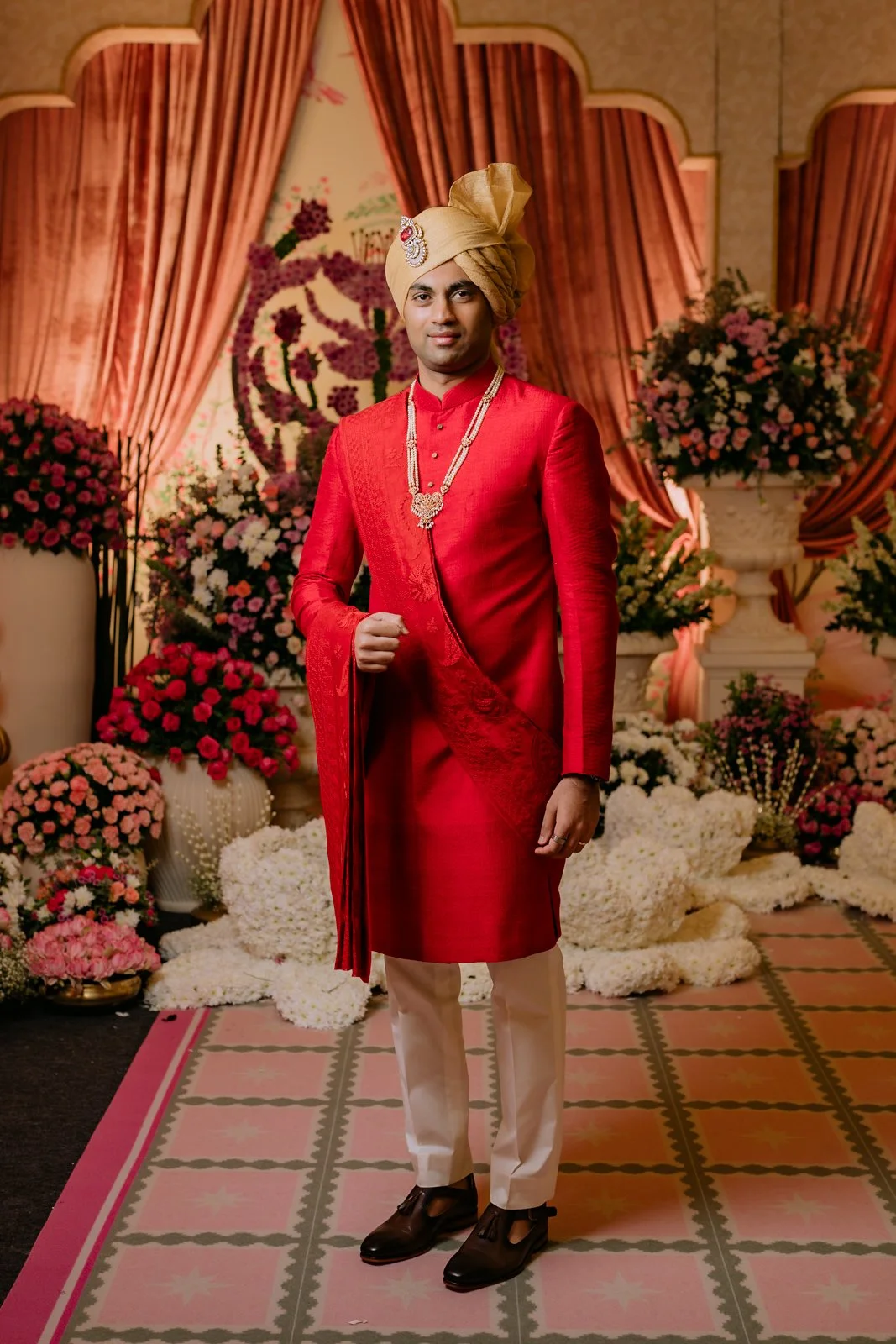 Portrait of Akhil in a red sherwani at Bangalore Palace