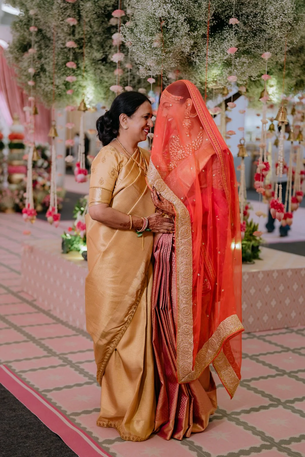 Shrishti in a red veil with her mother at Bangalore Palace