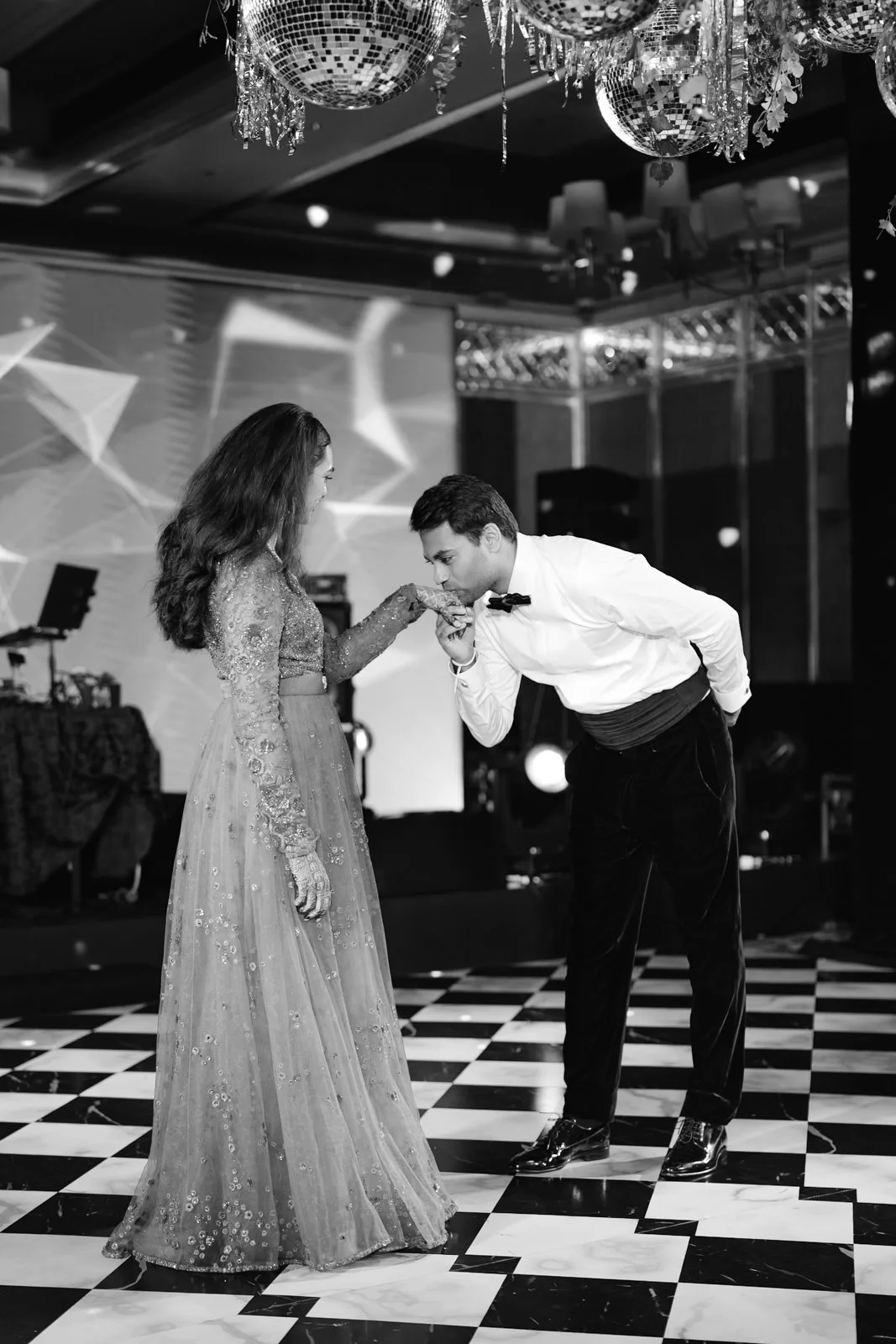 Akhil kissing Shrishti's hand on the dance floor, black and white