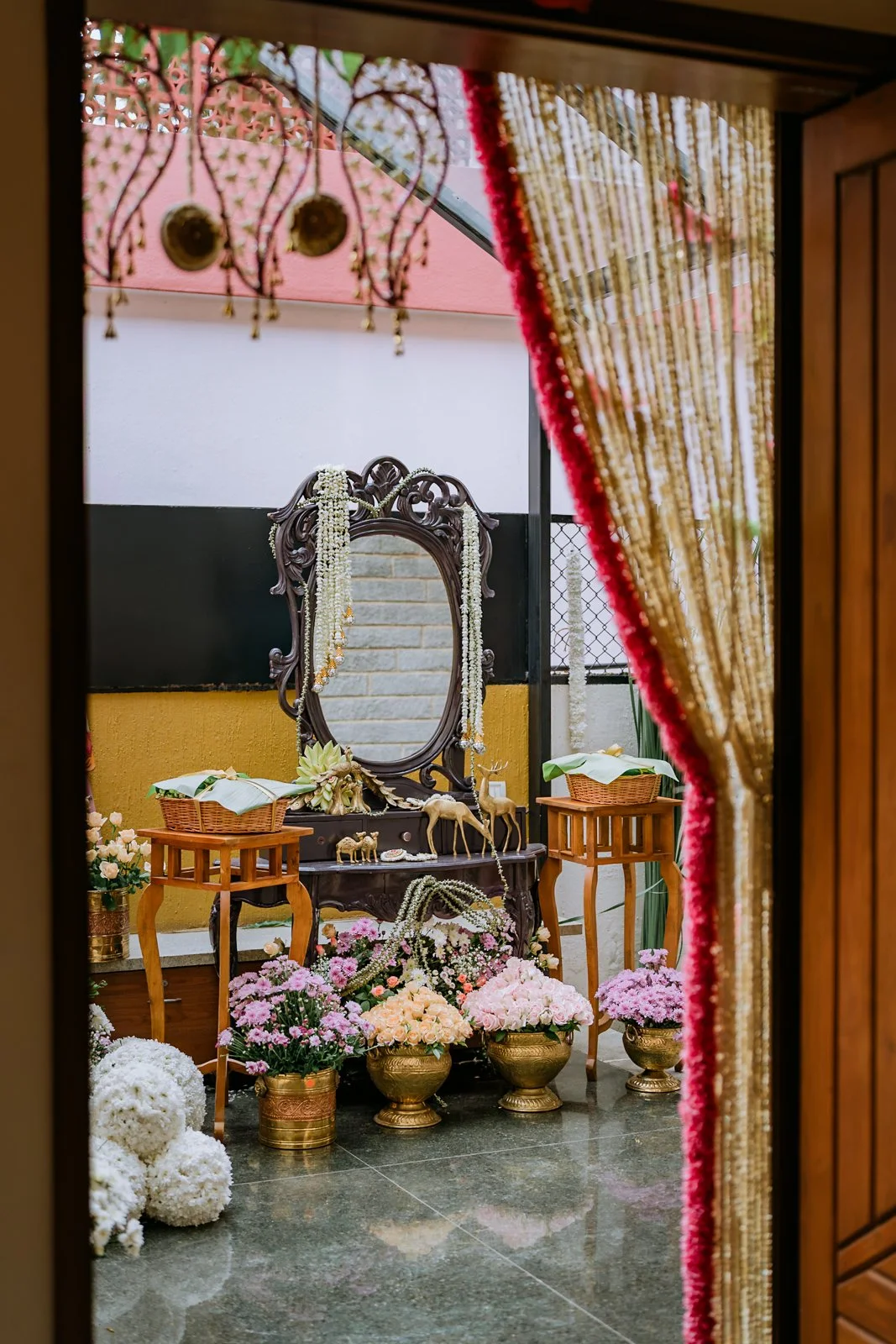 Haldi decor at Shrishti's home: a carved mirror framed by a jasmine curtain