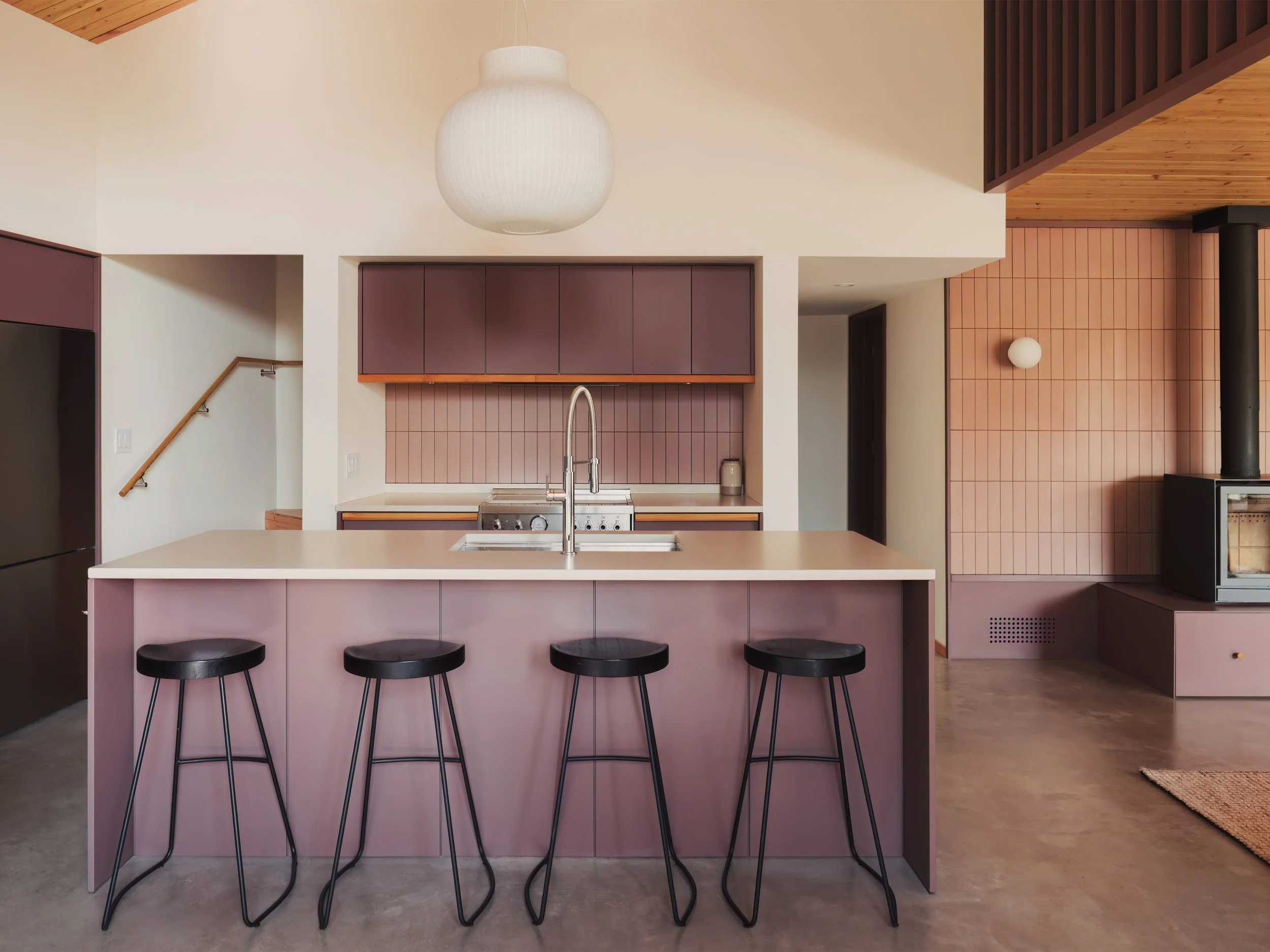 Kitchen island and fireplace of architectural cabin at Wabamun, Alberta near Edmonton