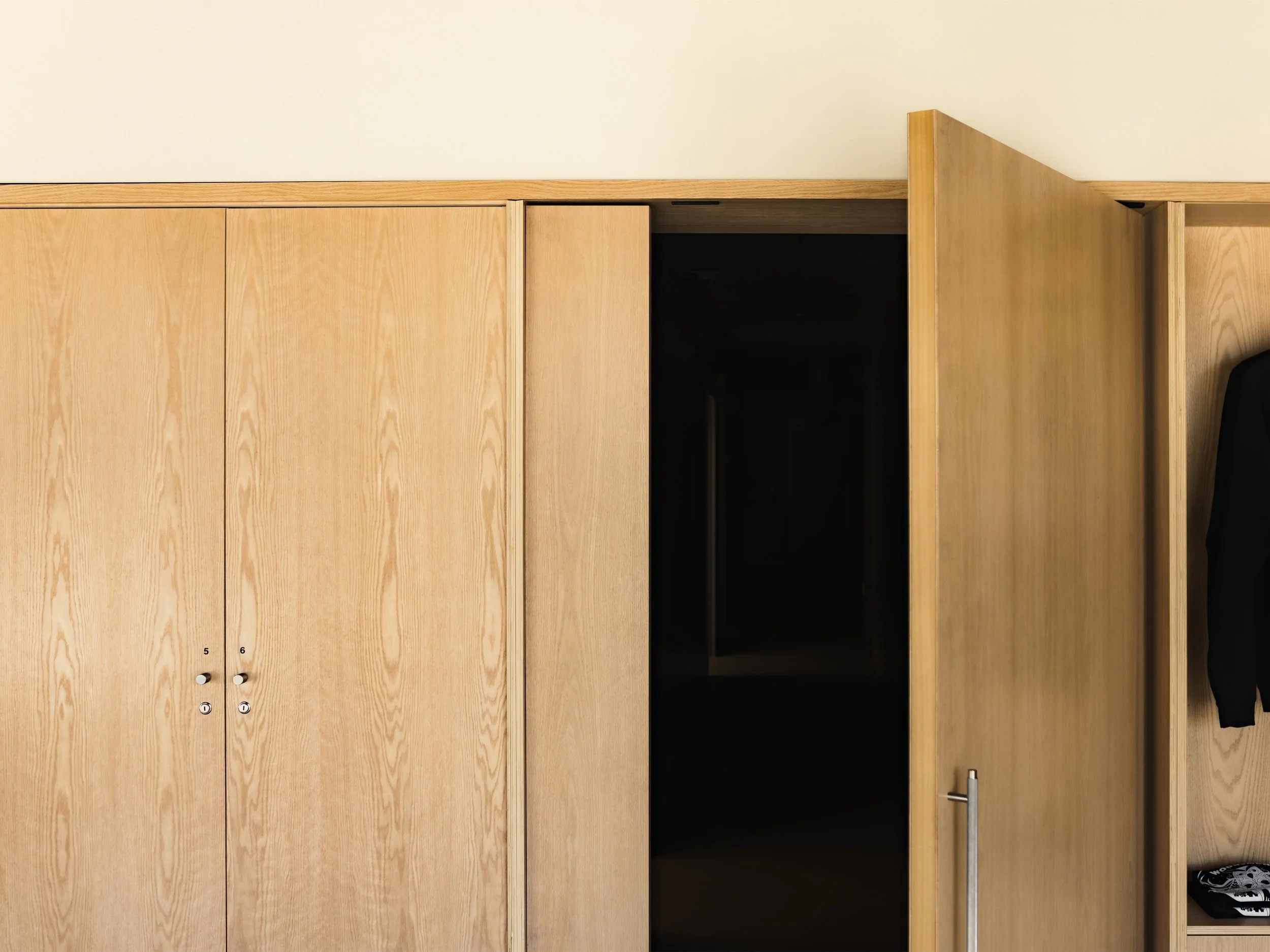 Custom pivot door at Escape City commercial interiors tenant improvement in Calgary, Alberta