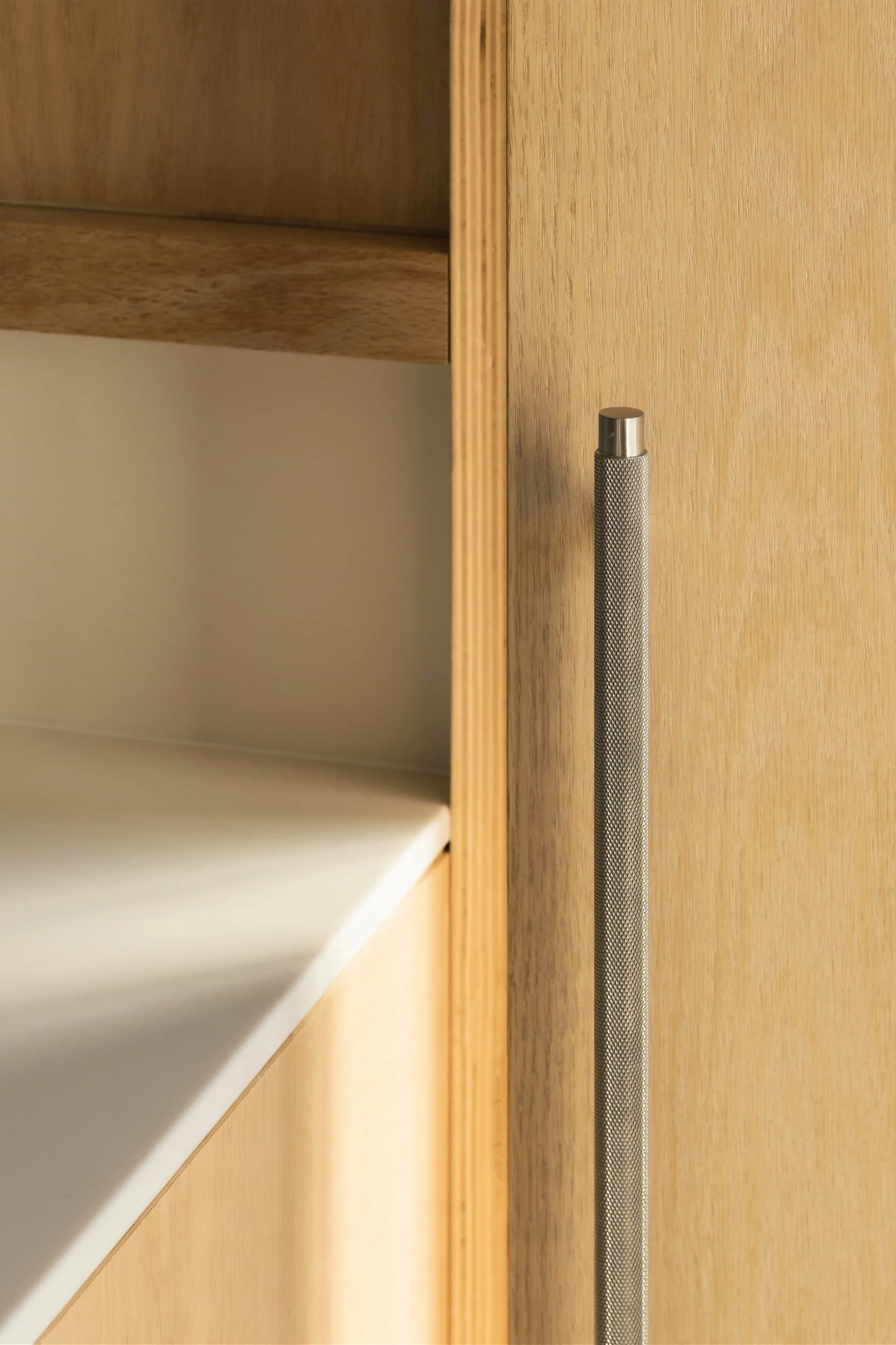 Close-up view of custom millwork and door at Escape City commercial interiors tenant improvement in Calgary, Alberta