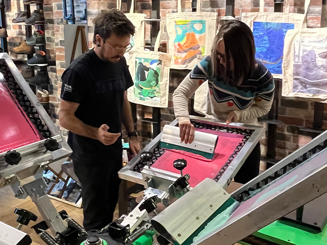 Cassandra Harrison screen-printing her illustrations