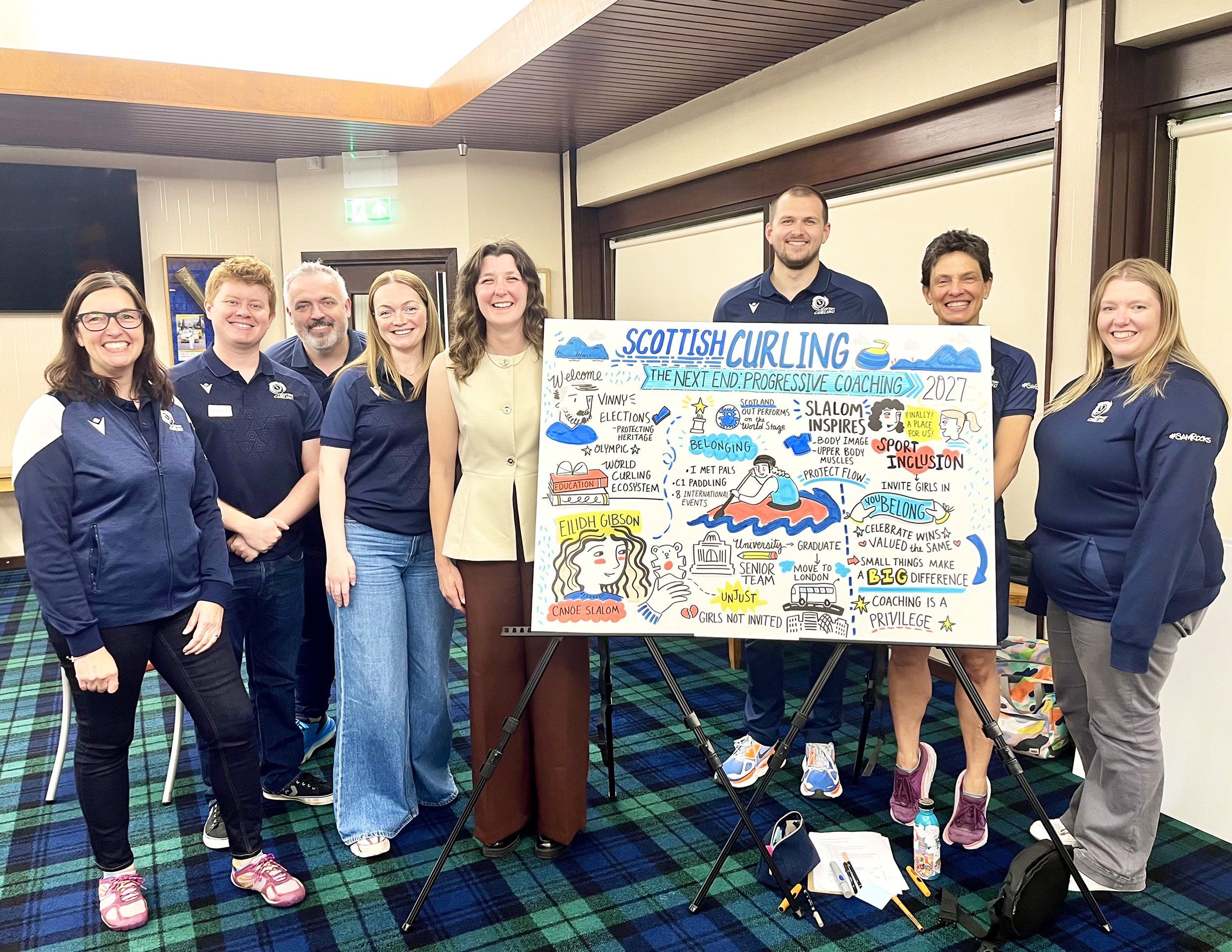 Scottish Curling staff and canoe slalom champion Eilidh Gibson standing around a live illustration board created by Cassandra Harrison in Hamilton Scotland illustrator included coaching is a privilege inviting girls into sport slalom inspires
