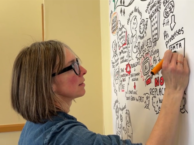 Cassandra Harrison creating a hand-drawn live event illustration