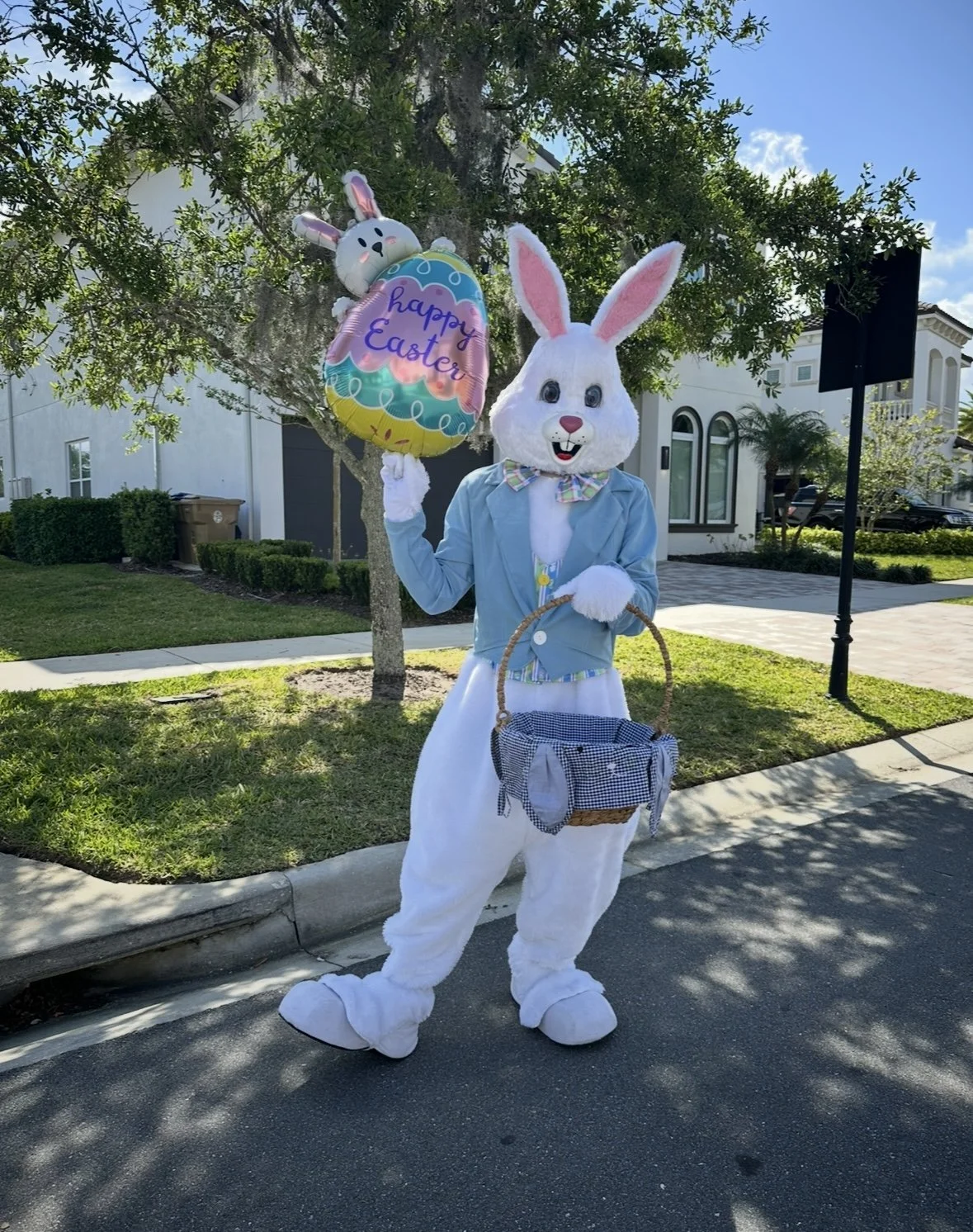 Easter Bunny performer at a spring holiday celebration with children.