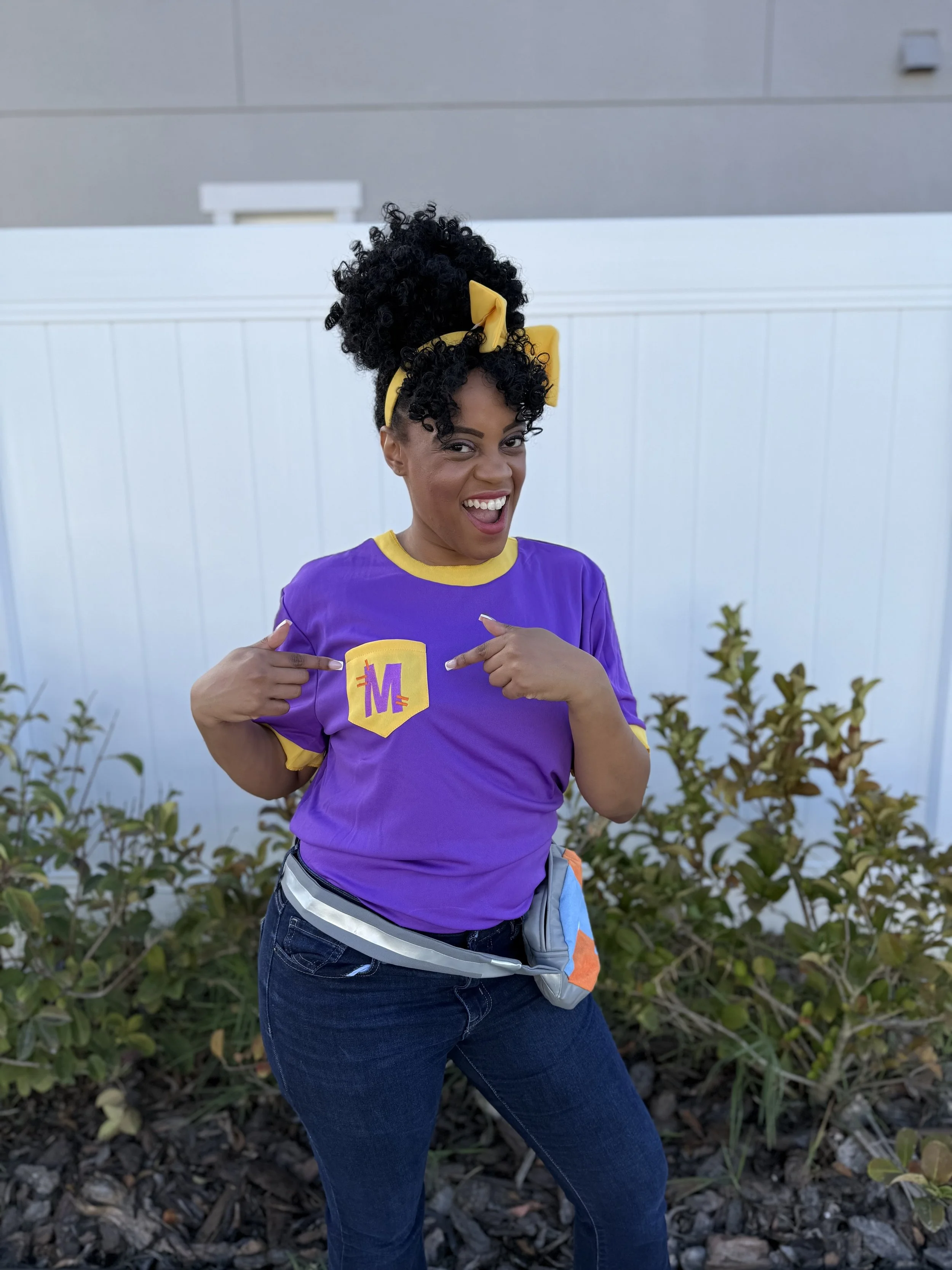 Meekah-inspired children's entertainer smiling with kids at a birthday party.