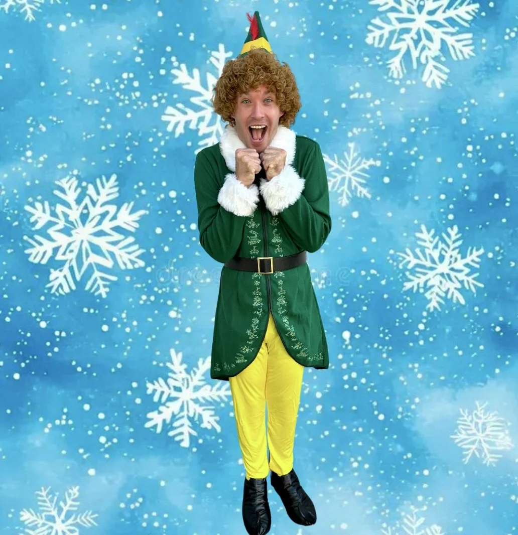 Buddy the Elf-inspired holiday character performer at a Christmas party with children.
