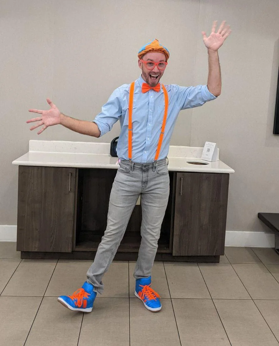 Blippi-inspired children's entertainer having fun with kids at a birthday party.