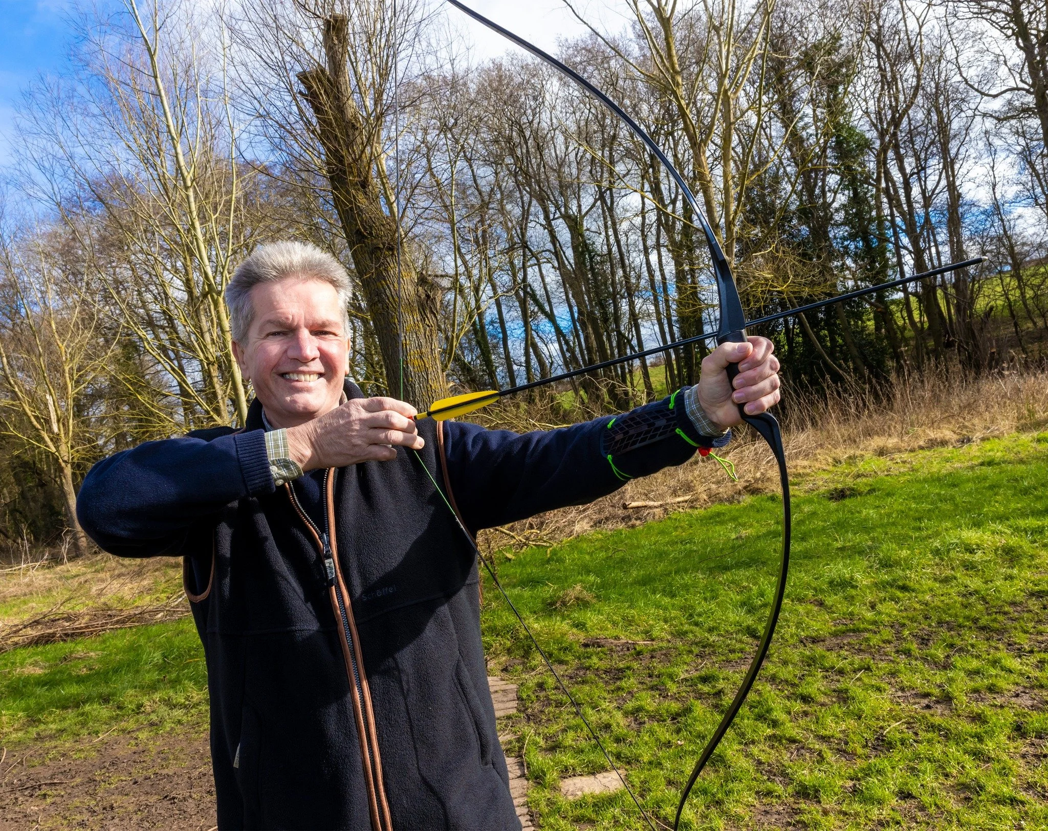 Grinning man with bow and arrow
