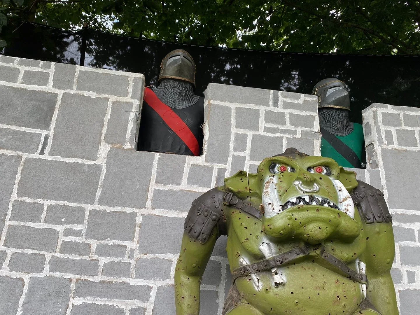 3D knight and orc targets with a backstop painted to look like castle battlements
