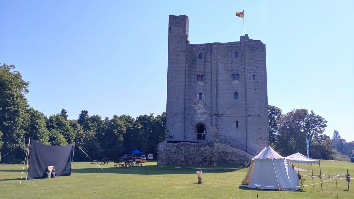Have-a-go archery range with white tent set up at Hedingham Castle, Essex