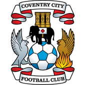The Coventry City Football Club crest featuring a shield with a castle, two birds, a soccer ball, a flame, and banners.