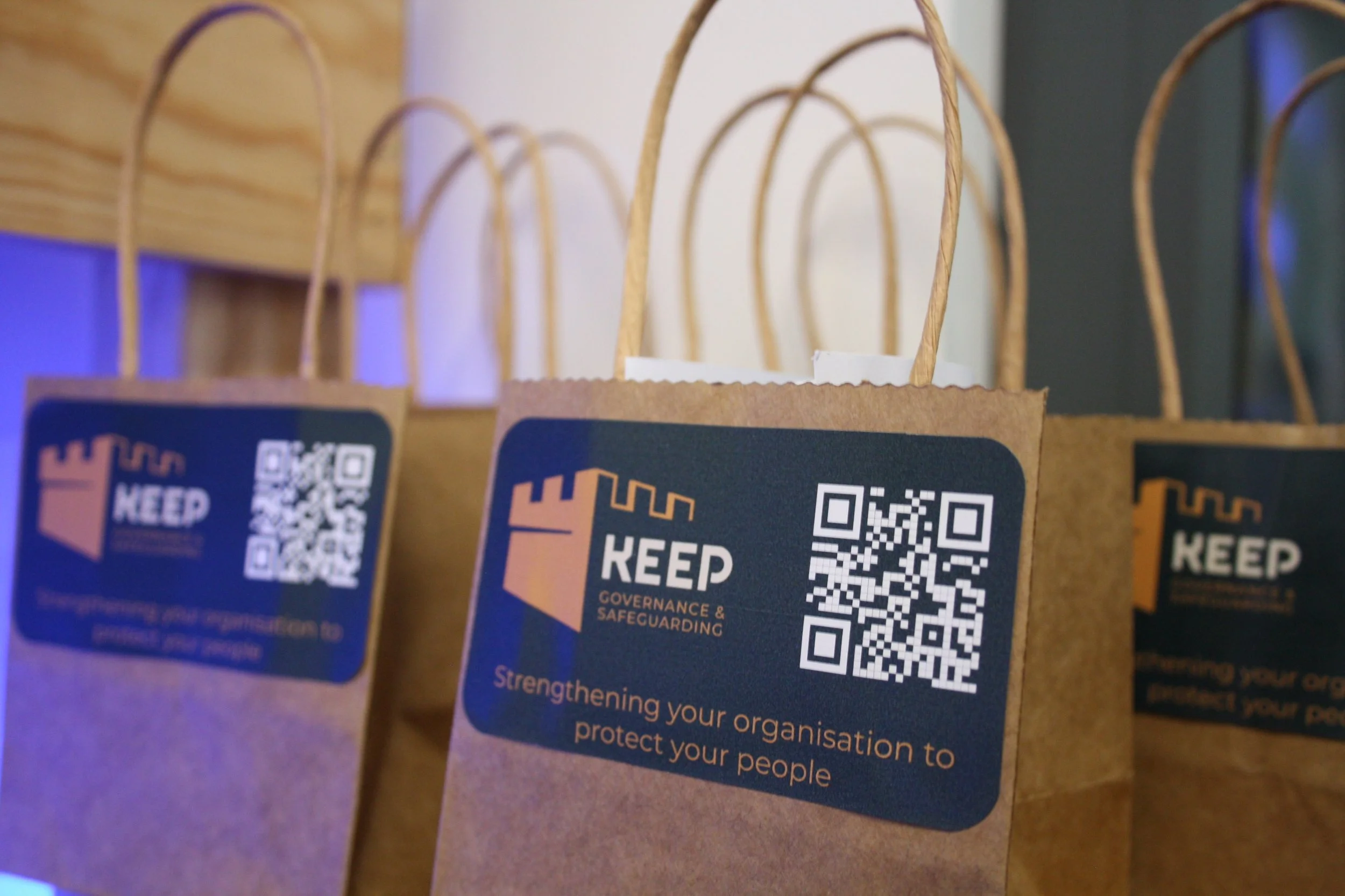Gift bags from our 10th birthday party. A small brown bag with the Keep Governance and Safeguarding logo on.