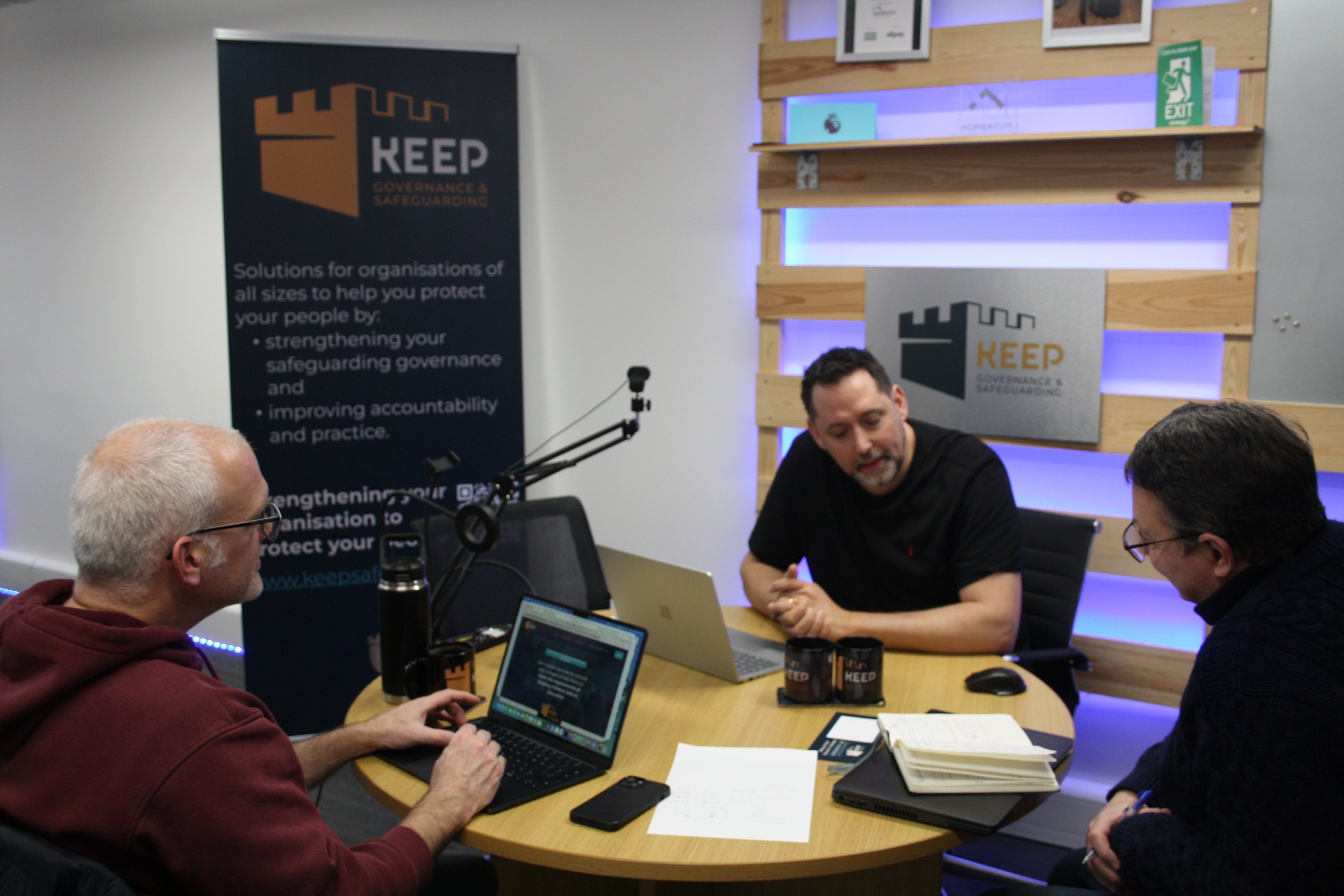 Andy Churcher and our associate safeguarding consultants in a meeting, discussing plans for an upcoming conference for education providers.