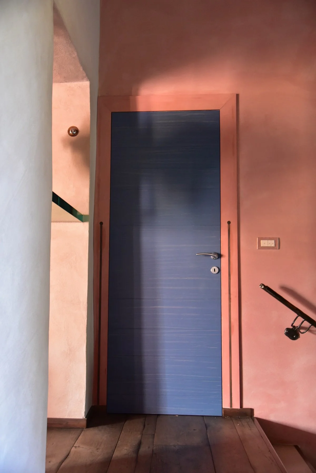 Tuscan ruin revived, with pink lime wash and modern blue doors