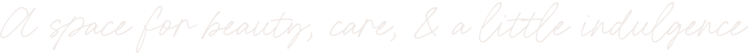 The image contains faint, cursive text that reads 'a space for beauty care, & a little indulgence' in a soft beige color.