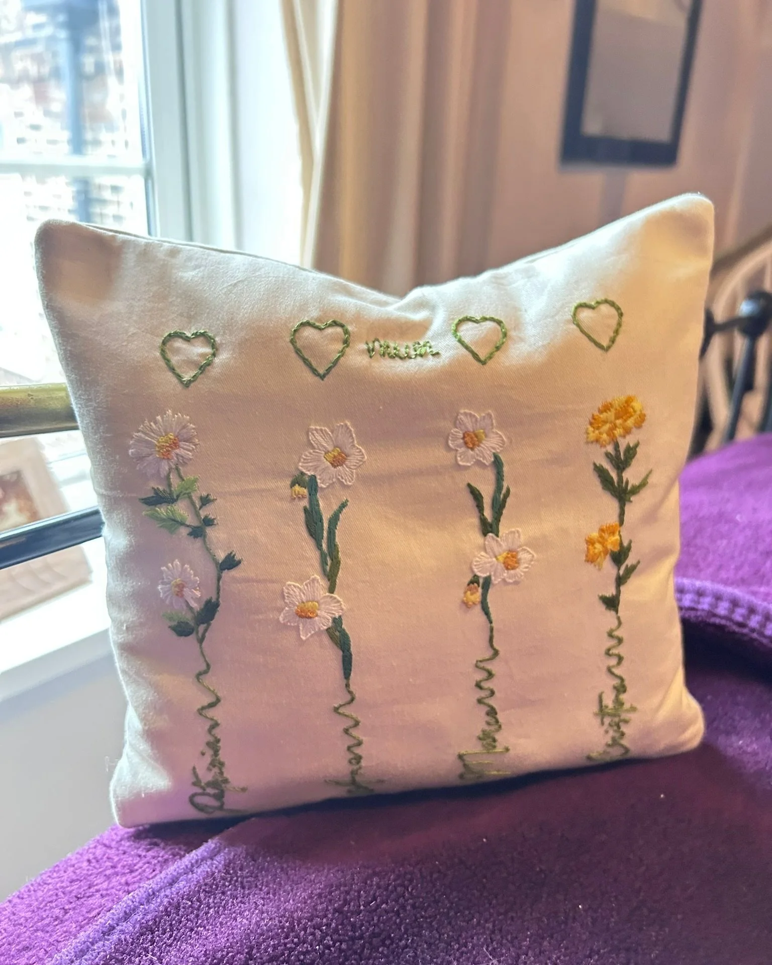 Decorative embroidered pillow with personalized names followed by each individual birth flower. Using Cream cotton fabric with  4 hearts to symbolizing one for each child