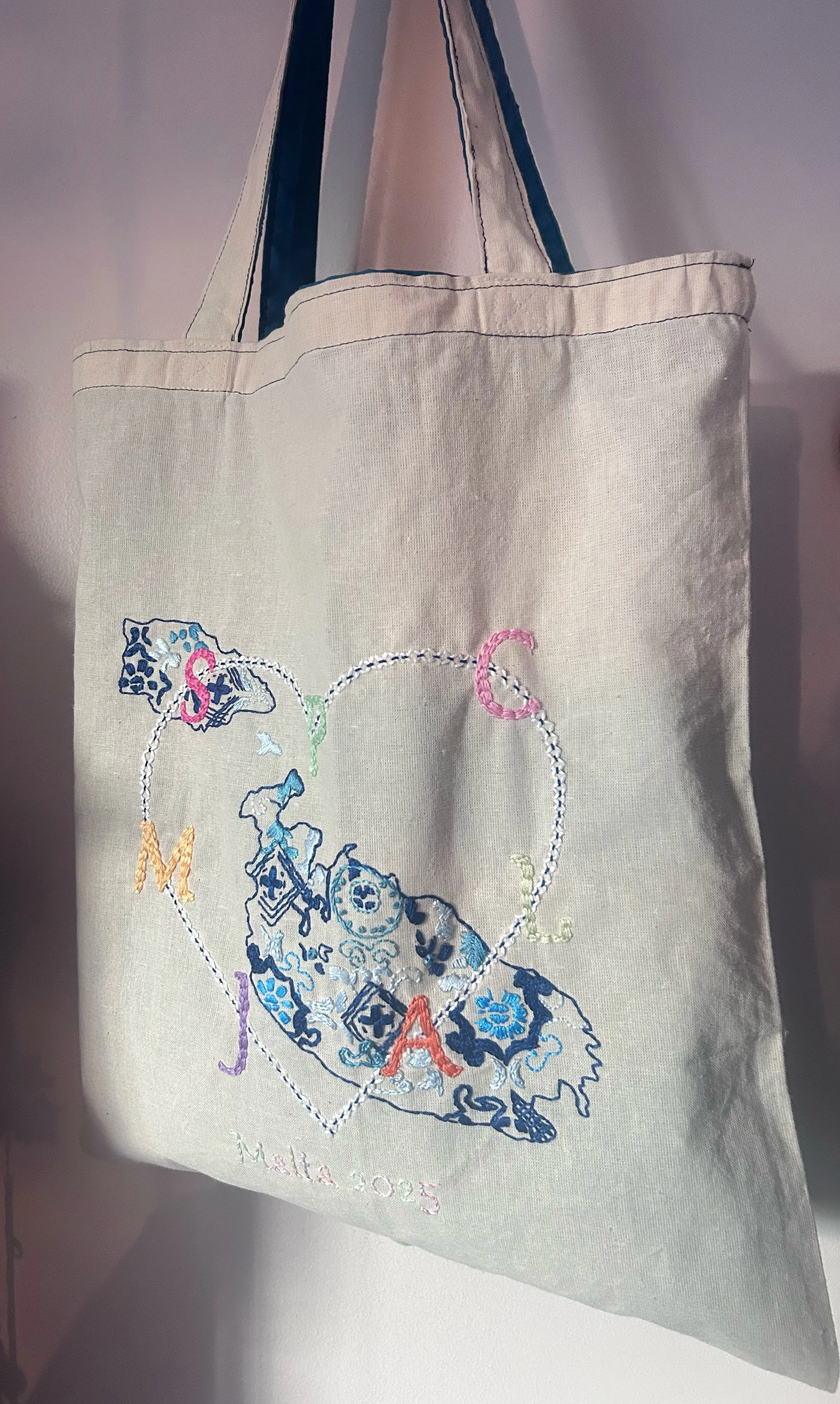 Wedding Keepsake Linen tote bag, hand embroidered with decorative map of Malta and letters, including "SPCAJLM" the initials of all special people and word "Malta 2025."