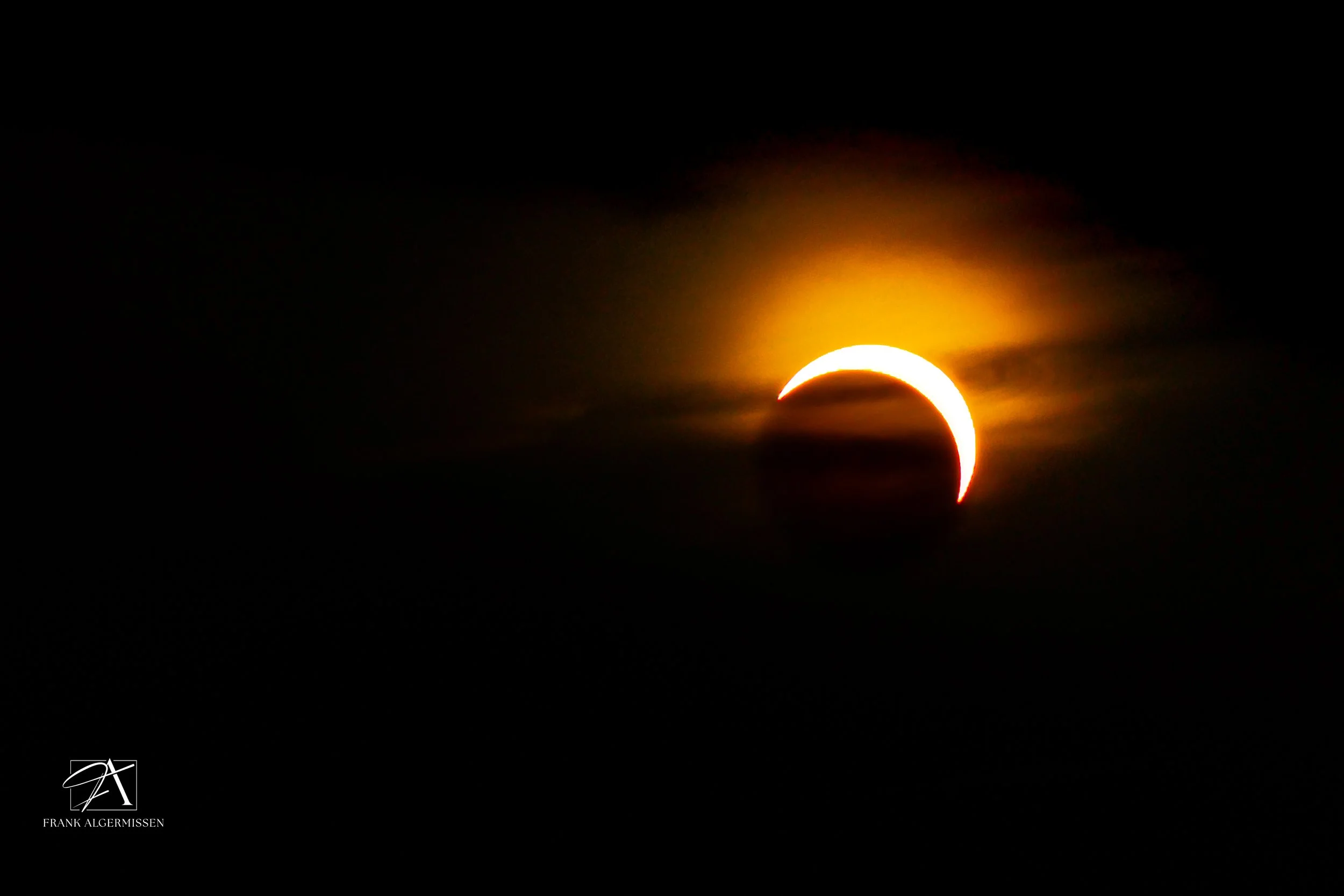 The Solar Eclipse 2026 with the Moon partially covering the burning Sun, creating a crescent shape against a dark sky.
