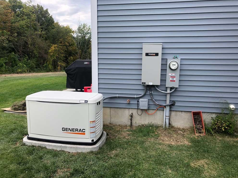 A residential backup generator outside a house, connected to the house's electrical system.