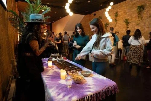 People at a buffet table at a social gathering or party, serving themselves food.