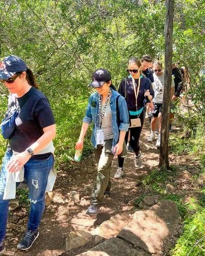 Group of people hiking on a forest trail.