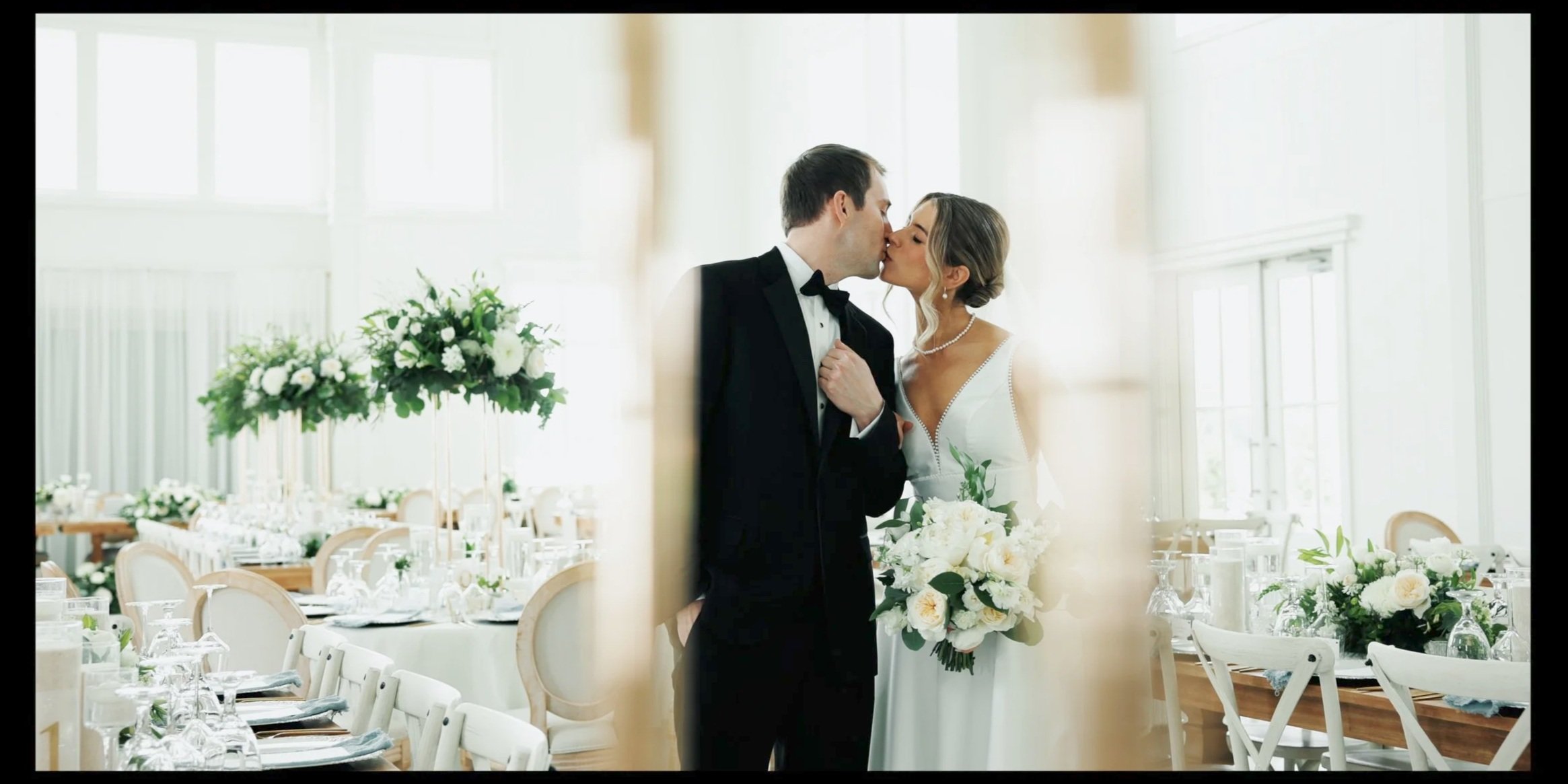 Bride and groom kissing at an elegant wedding reception captured by SBS Wedding Films