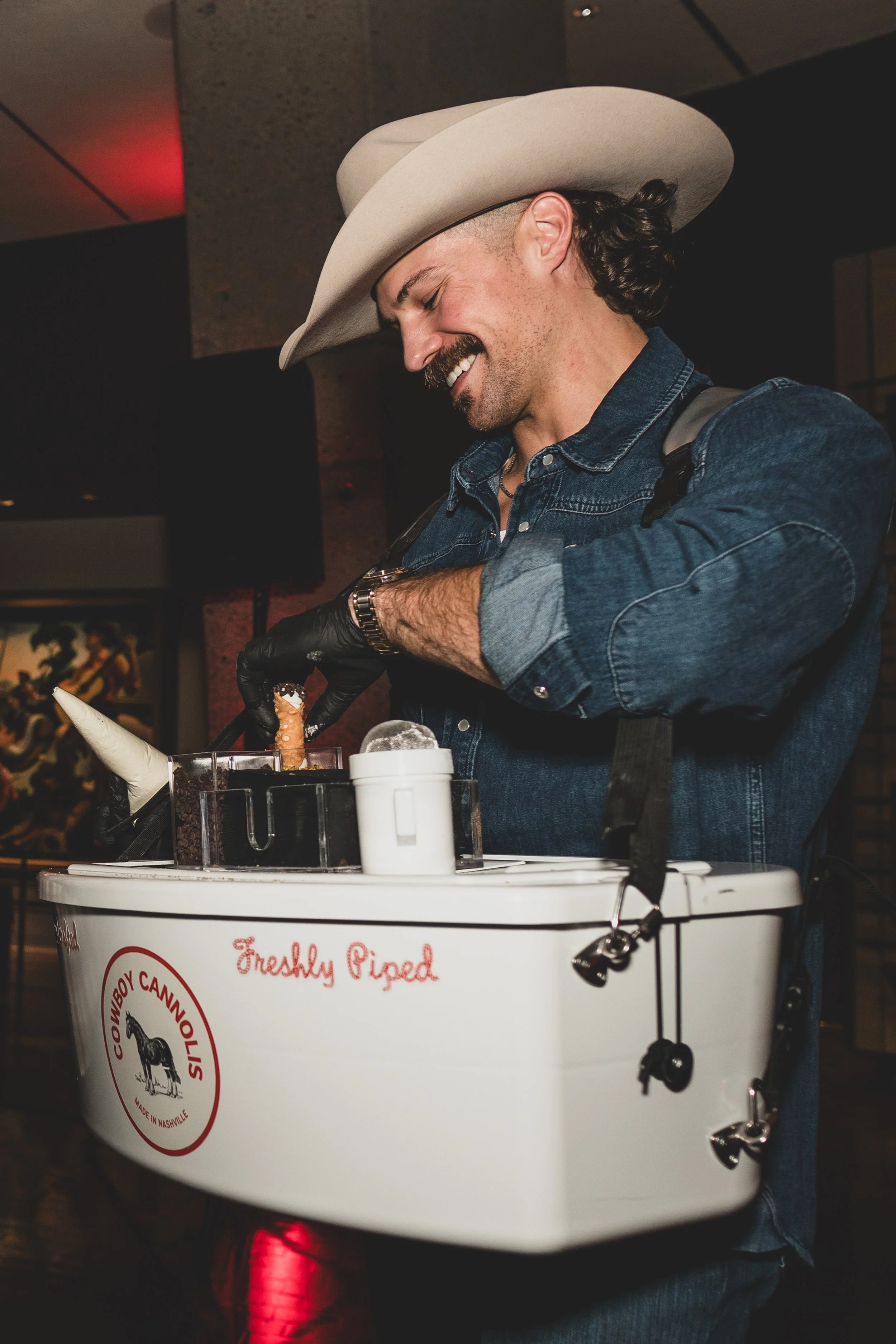 a Western Cowboy making a freshly piped cannoli in Nashville TN