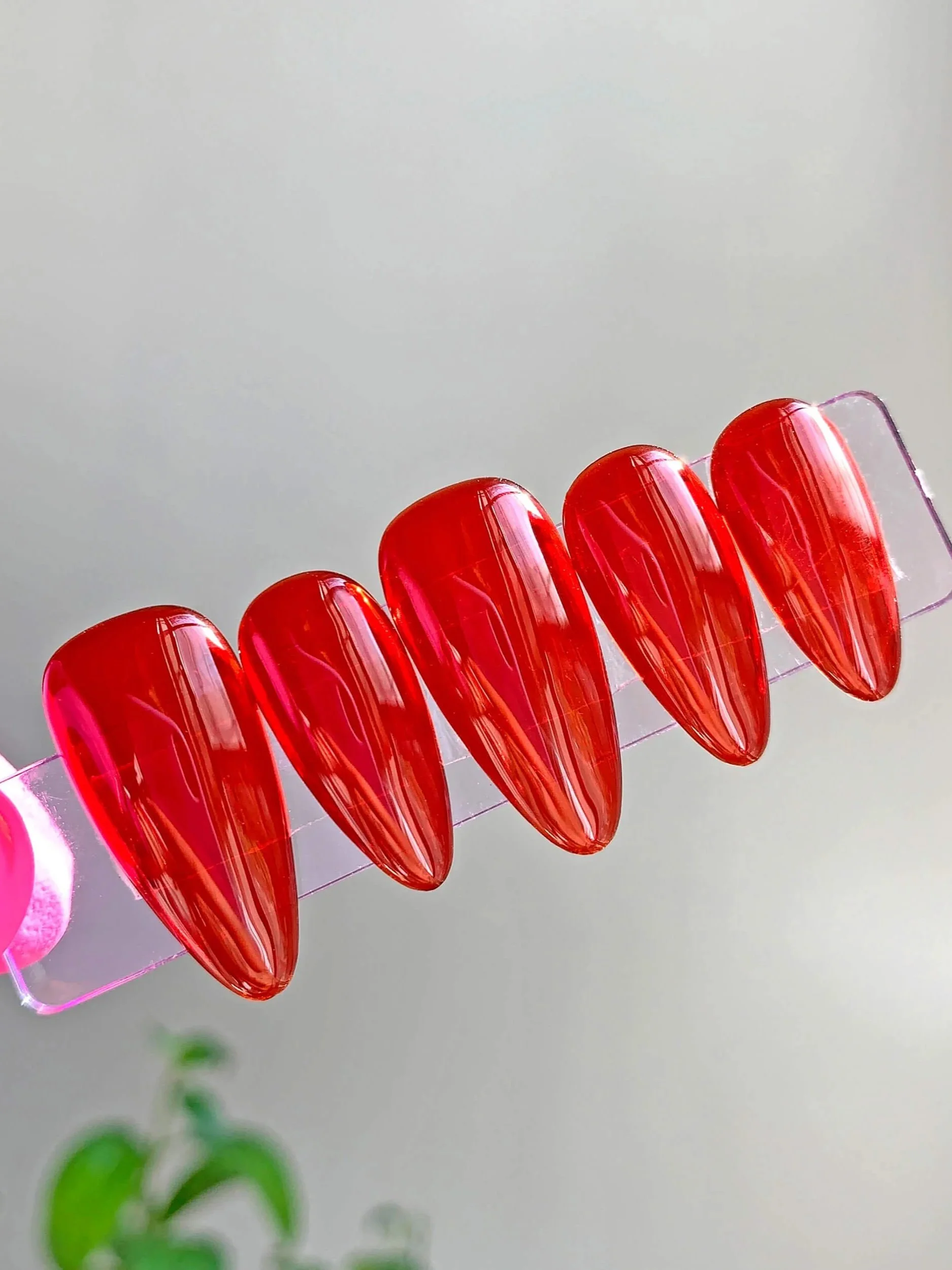 Red jelly press-on nails in short almond.