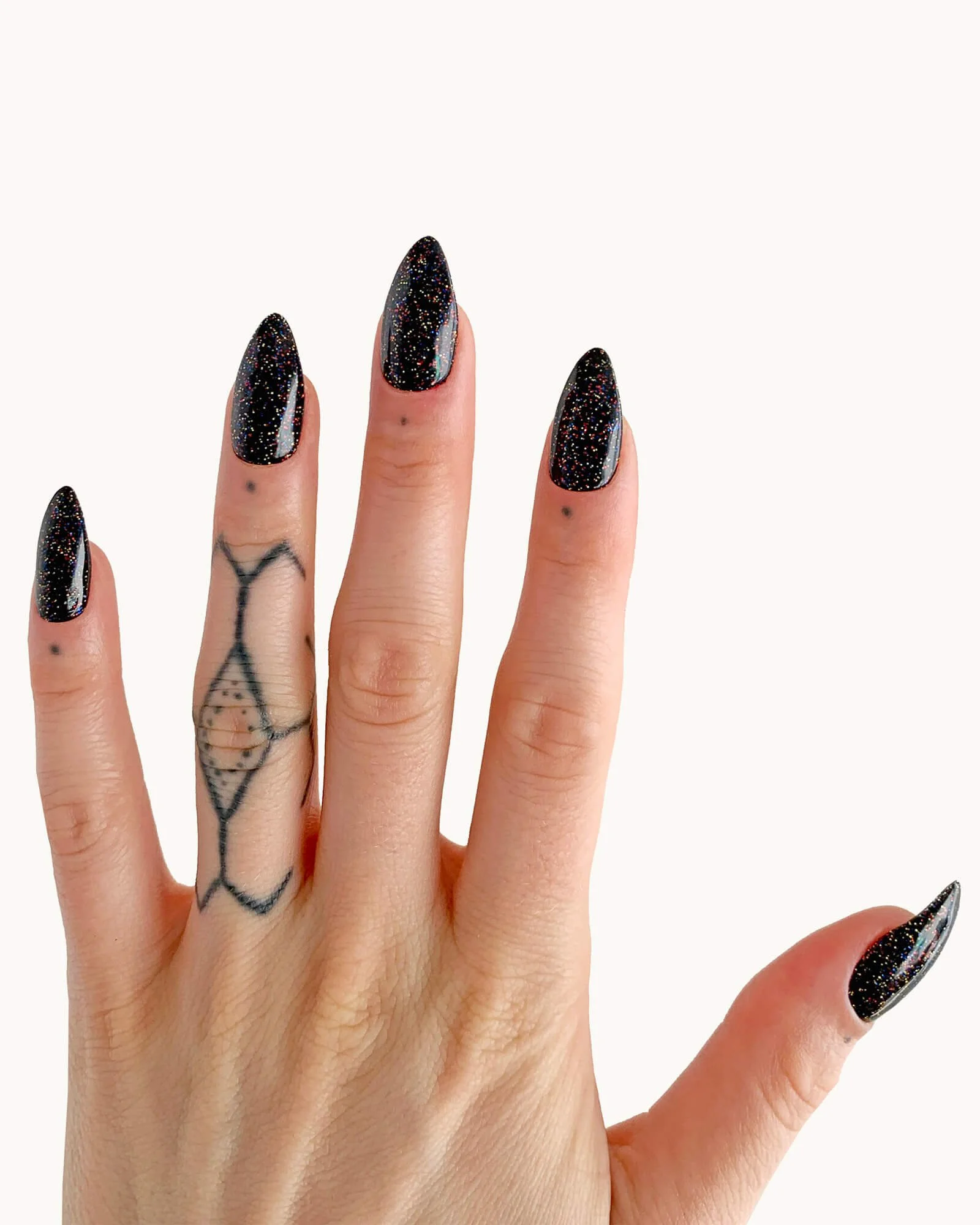 Model wearing a glittery black nail set in almond.