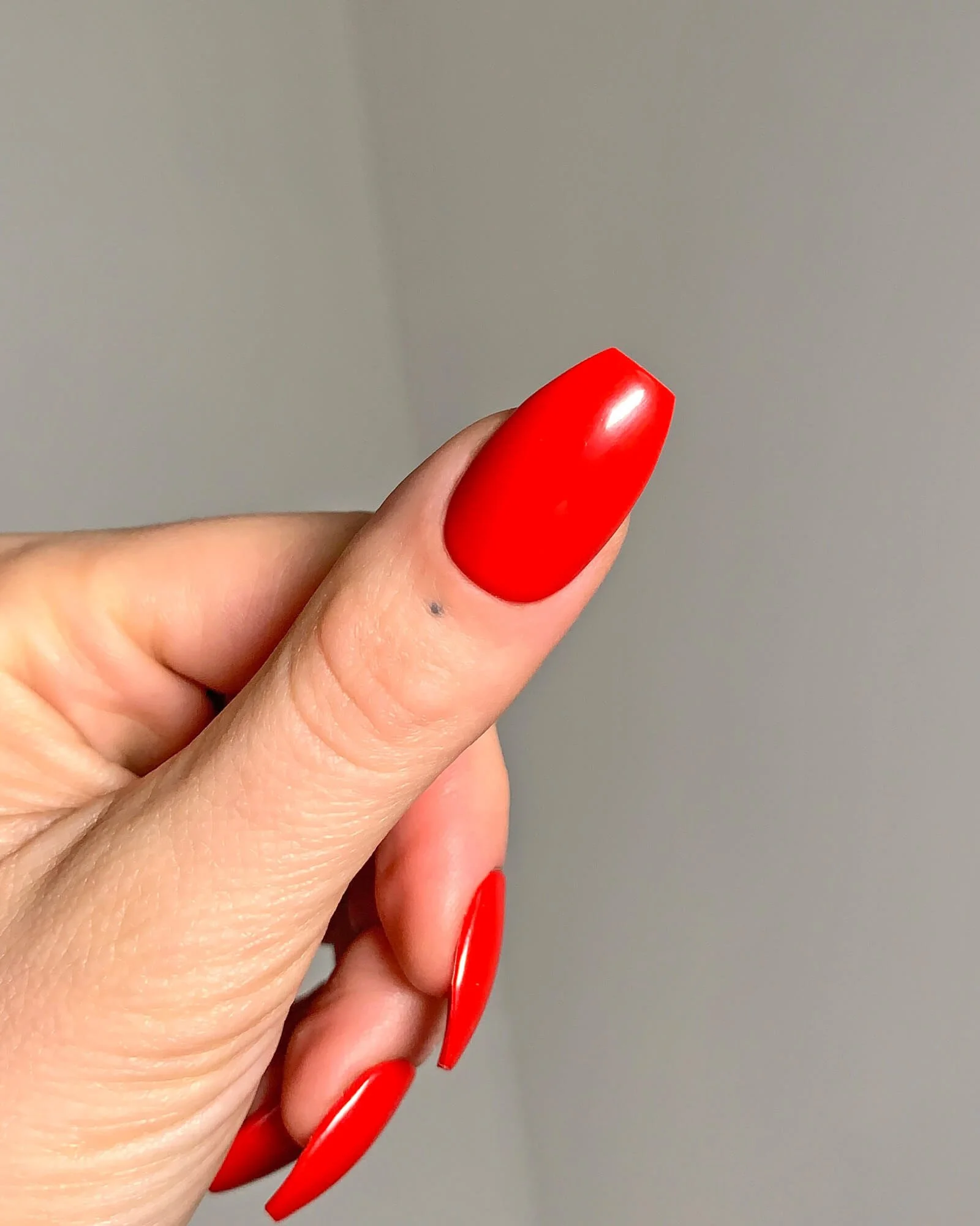 Thumb view of the retro, cherry red gel nails hand-painted by Rainbow in NYC..