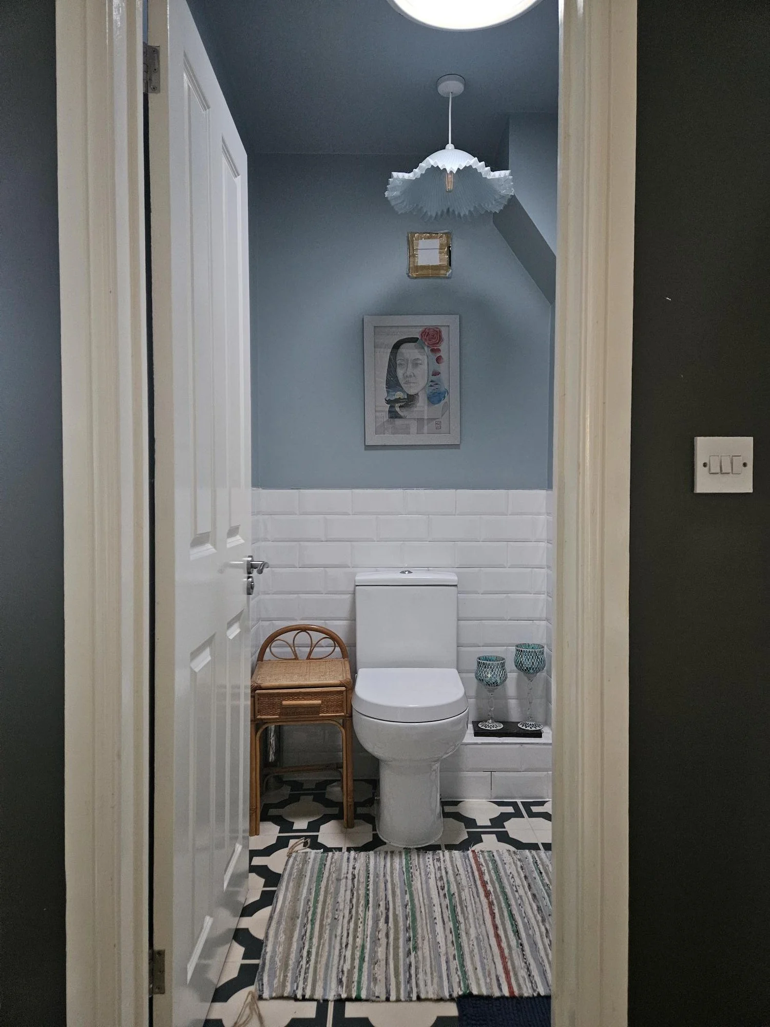 The downstairs w.c. Small but functional. We opted for a sun tunnel instead of a window. Soft blue walls with patterned luxury vinyl floor tiles blends traditional with contemporary.
