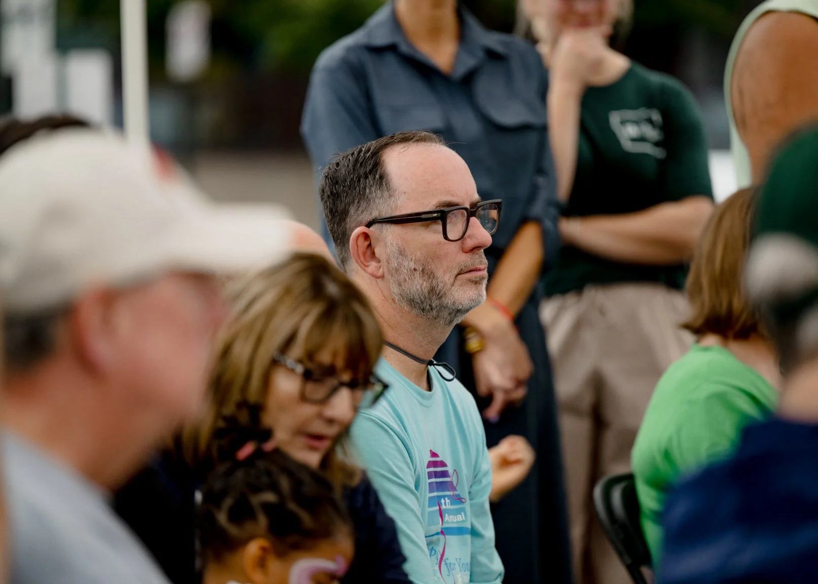 People listening during the mural gathering.
