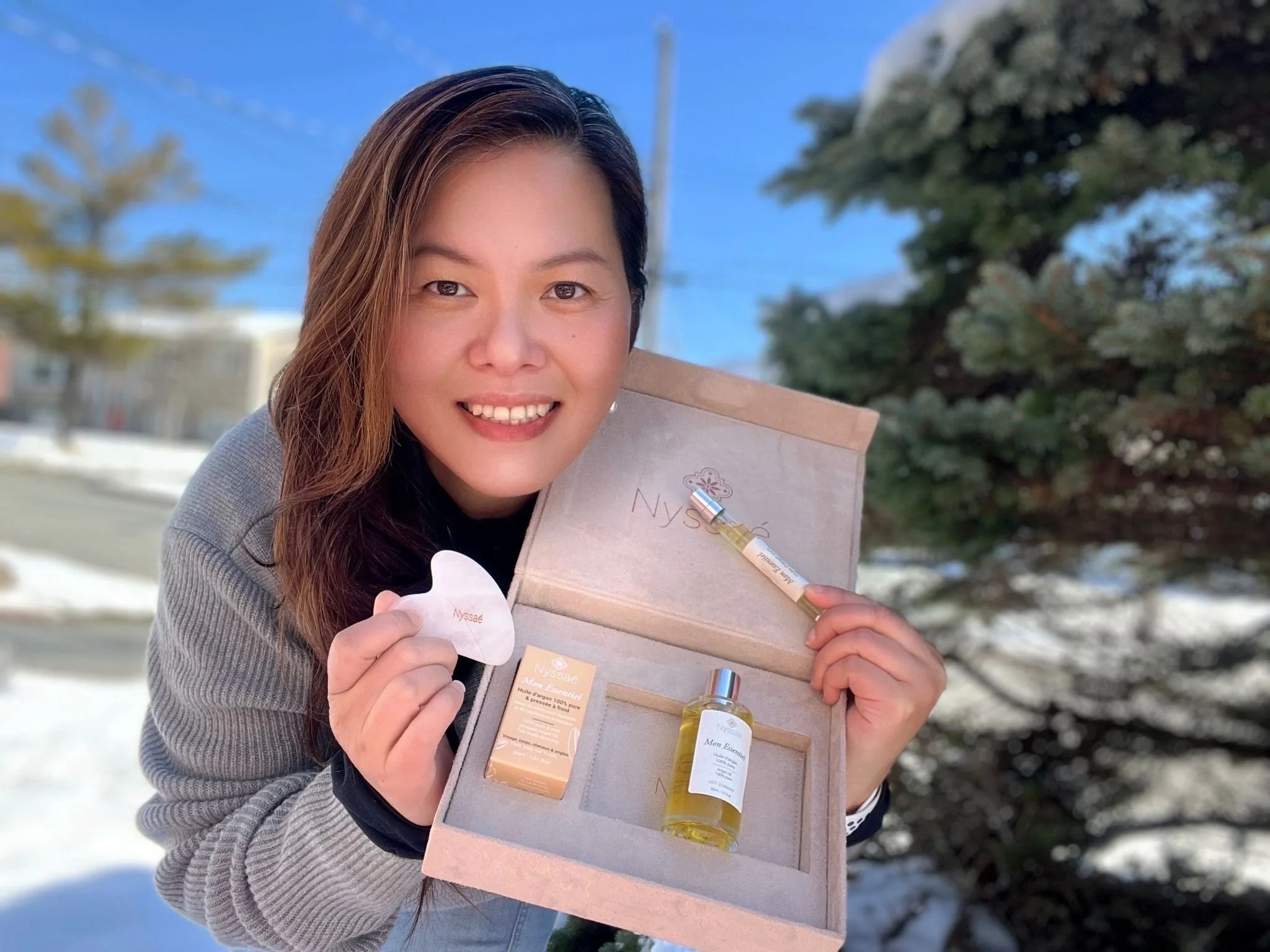 Tracy Kwan holding her products