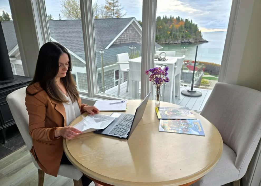 Anne Laurie working at a desk with her laptop open