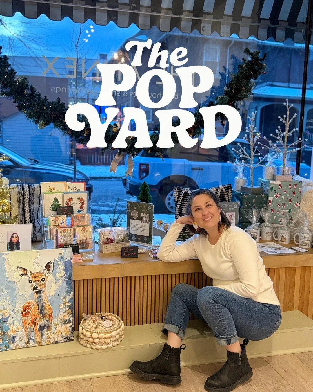 Gabi sitting in the window of the Pop Yard