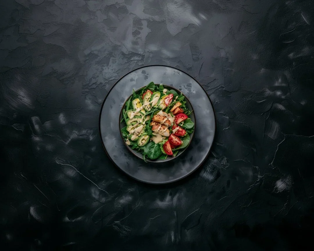 Overhead view of a salad with grilled chicken, avocado, and cherry tomatoes for natural GLP-1 support