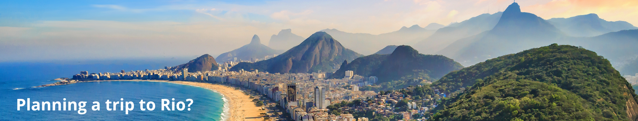 A panoramic view of Rio de Janeiro with mountains, beaches, and city skyline during daytime.