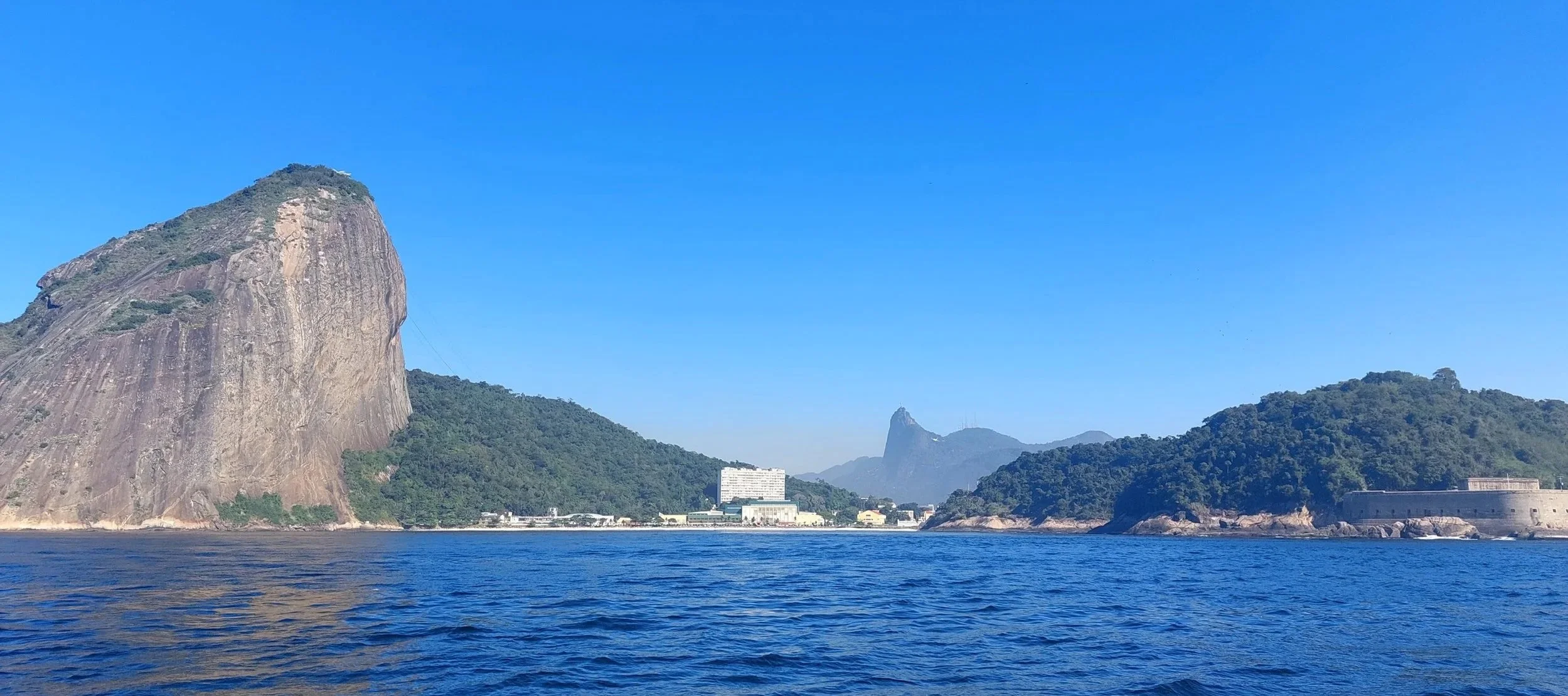 View of Sugarloaf Mountain and Christ the Redeemer from a boat on Guanabara Bay, Rio de Janeiro