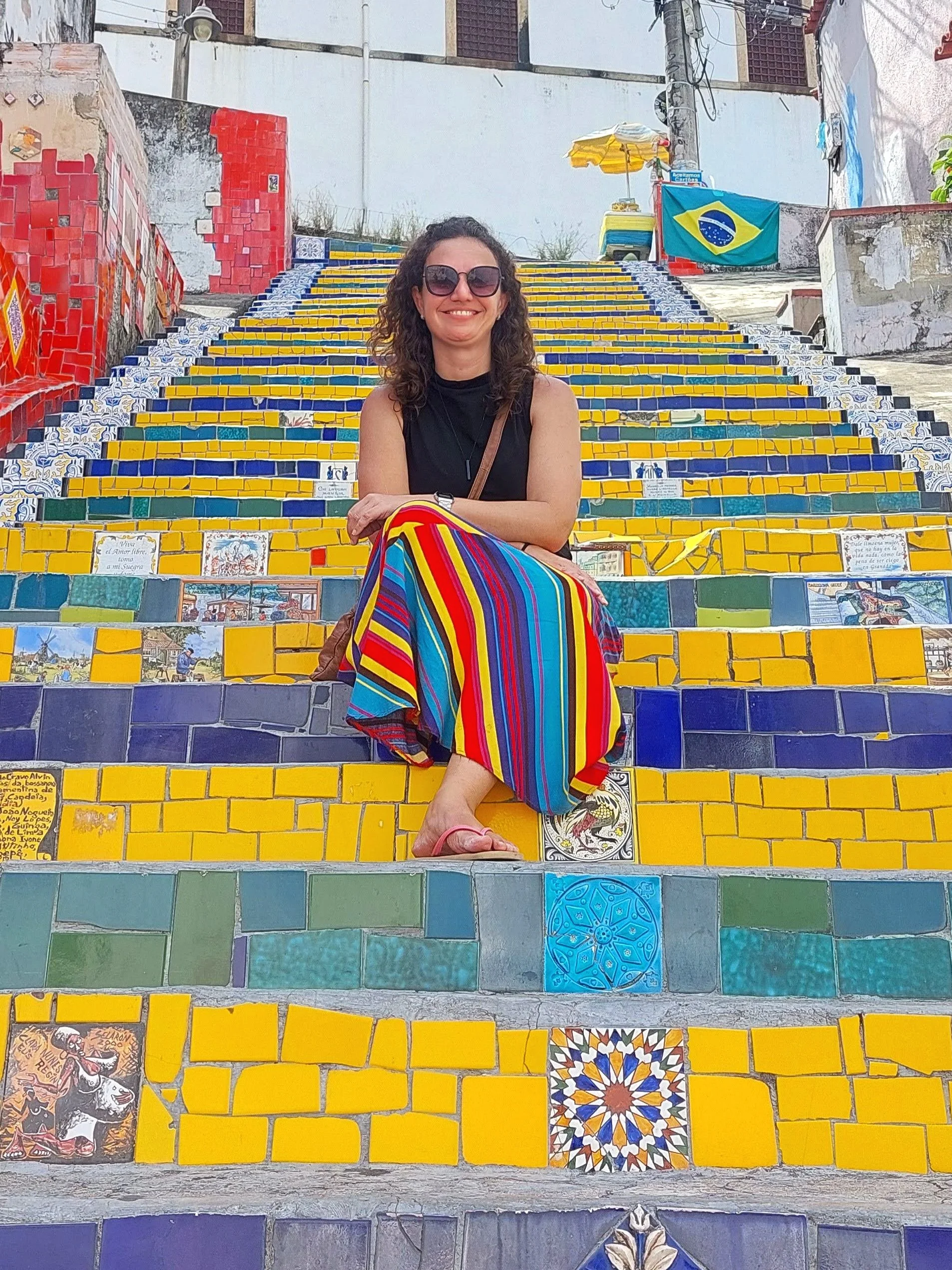 Karina, creator of Let's Rio sitting on Selaron steps, one of the most famous Rio's landmarks