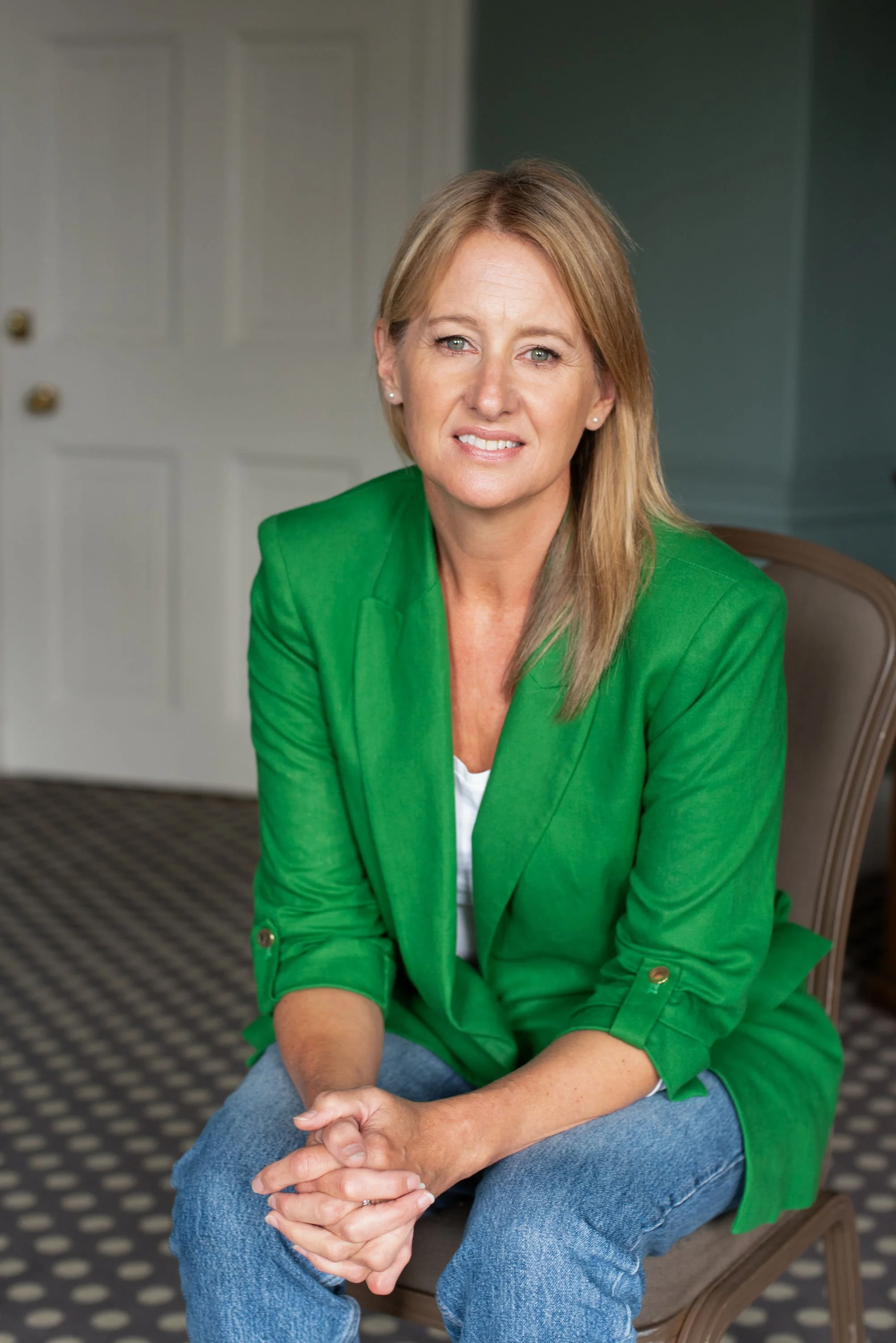 Kate of Clarity Coaching smiling at the camera in a green blazer.